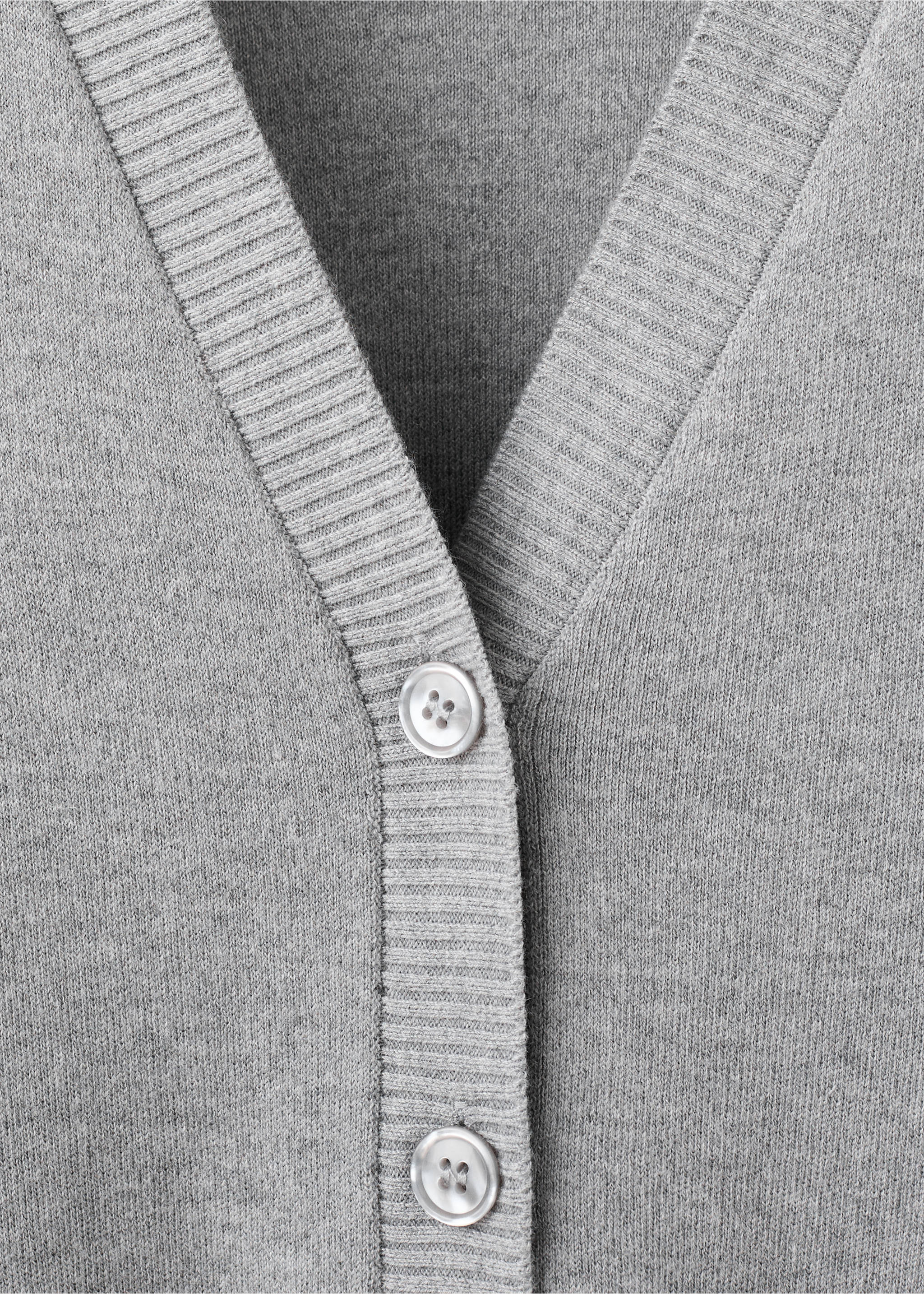 Close-up of a grey knitted cardigan featuring a V-neckline, ribbed trim and button placket., Medium Heather Grey. Ref: 27034774-00.