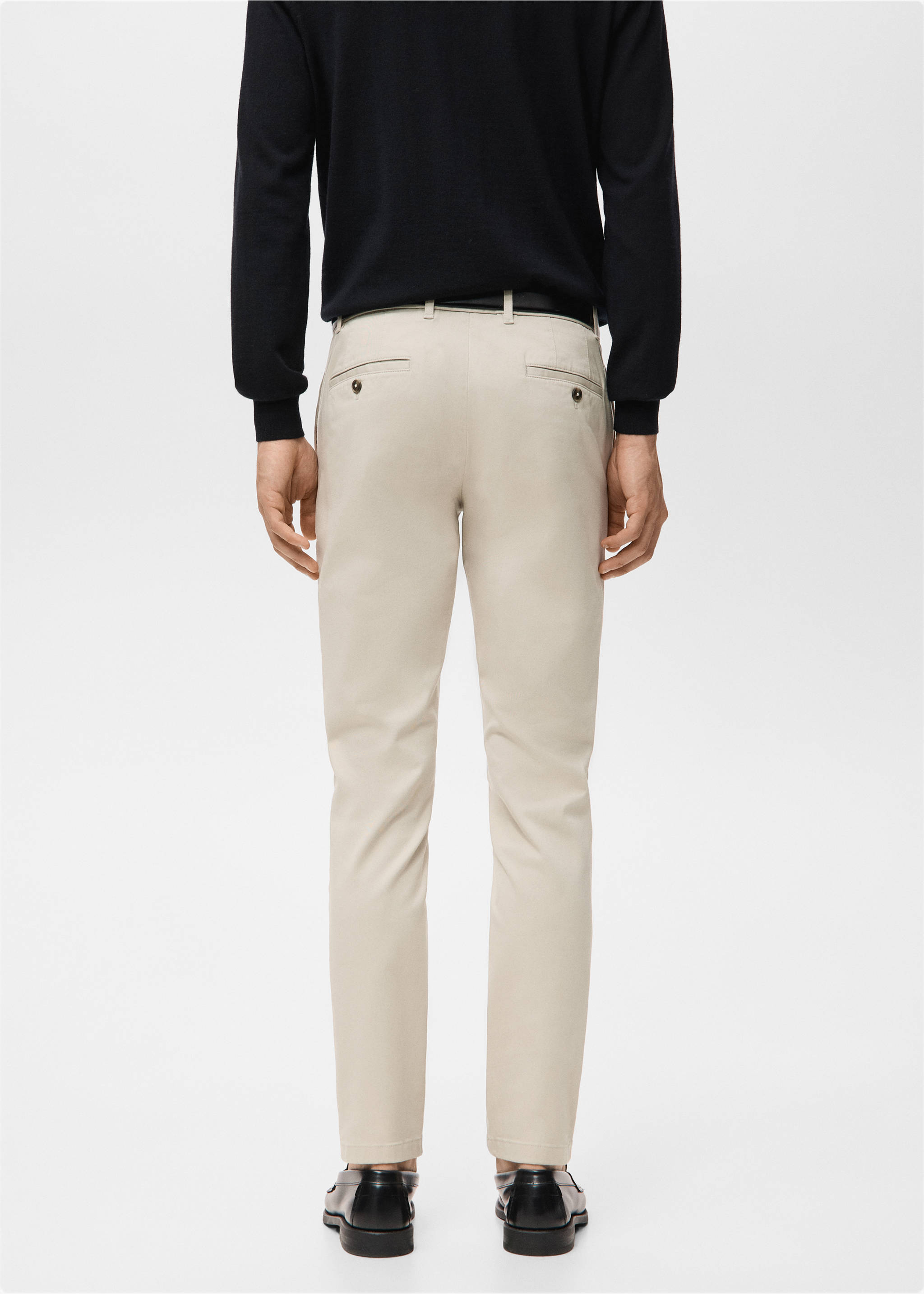Back view of beige trousers with back welt pockets, worn with a dark sweater., Sand. Ref: 27041187-00.