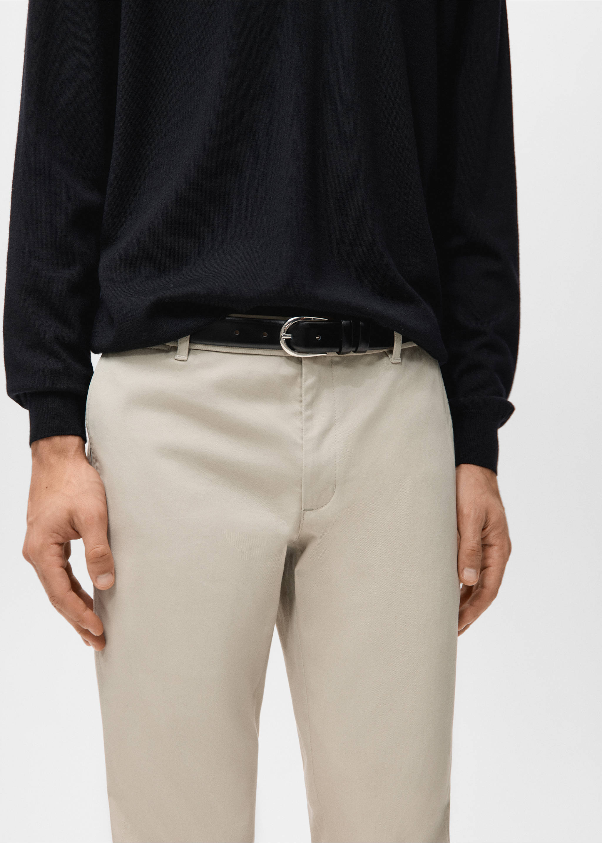Light beige trousers with a black leather belt and a black jumper., Sand. Ref: 27041187-00.