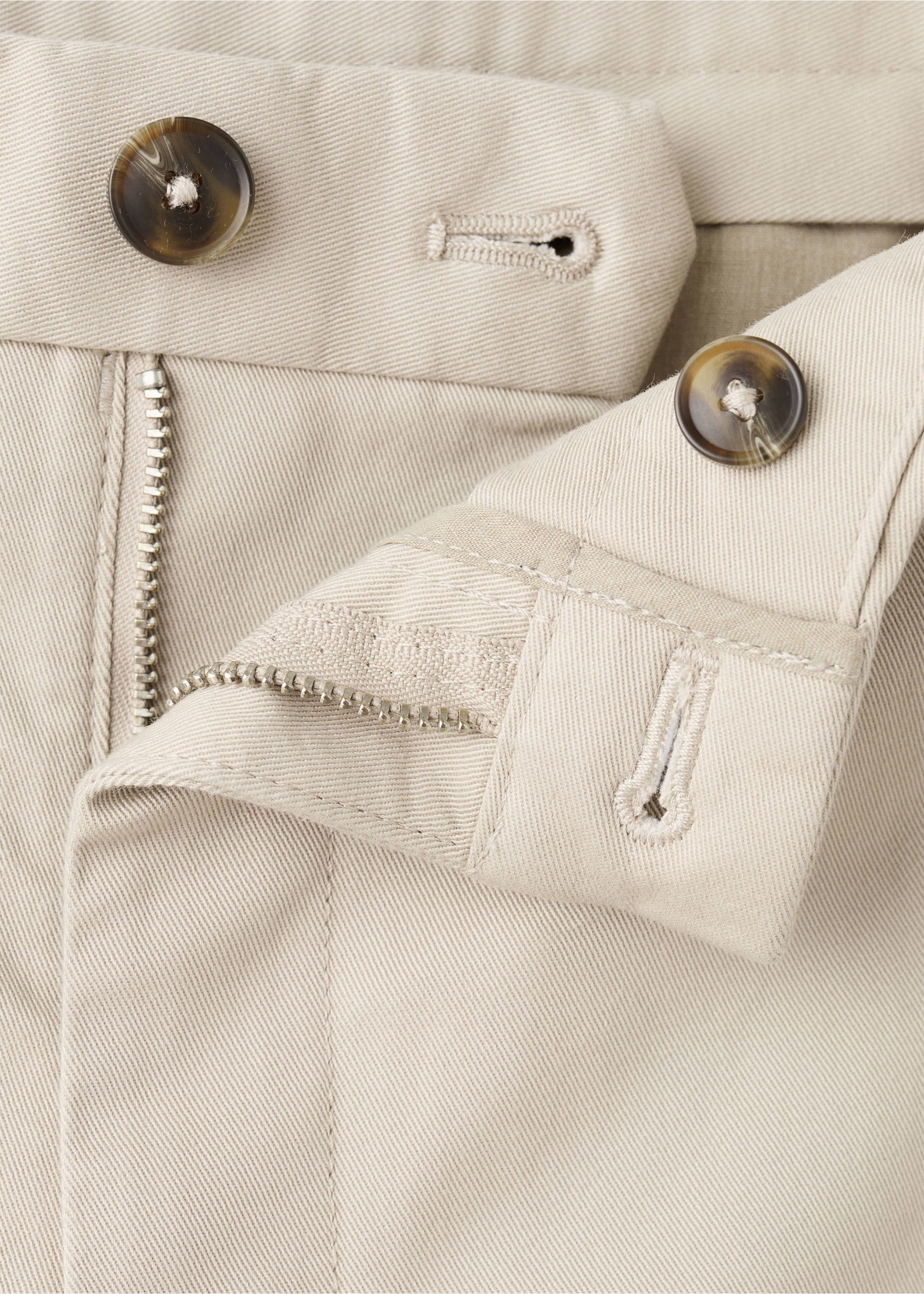 Beige trousers detail showing the waistband, tortoiseshell buttons, and zipper fly., Sand. Ref: 27041187-00.