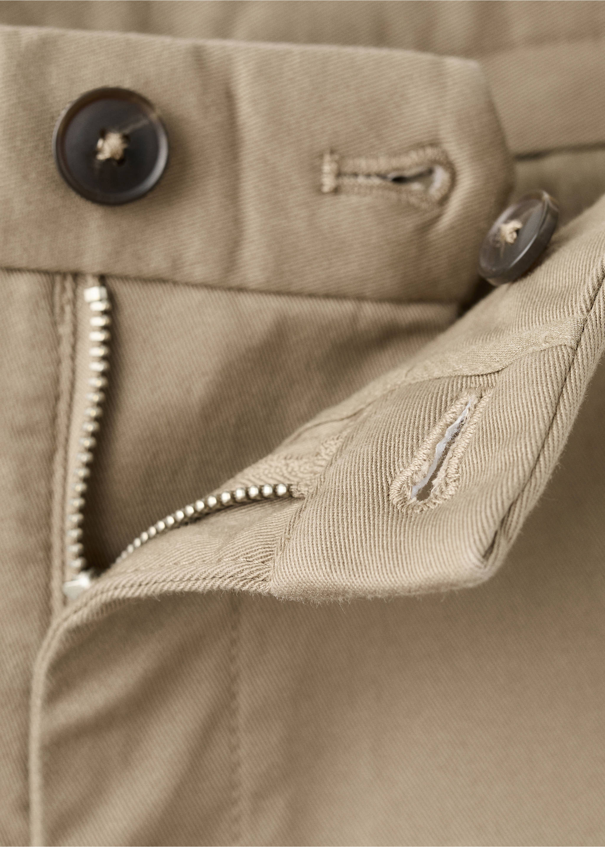 Close-up of beige men's trousers showing the waistband and zip fly detail., Beige. Ref: 27041187-00.