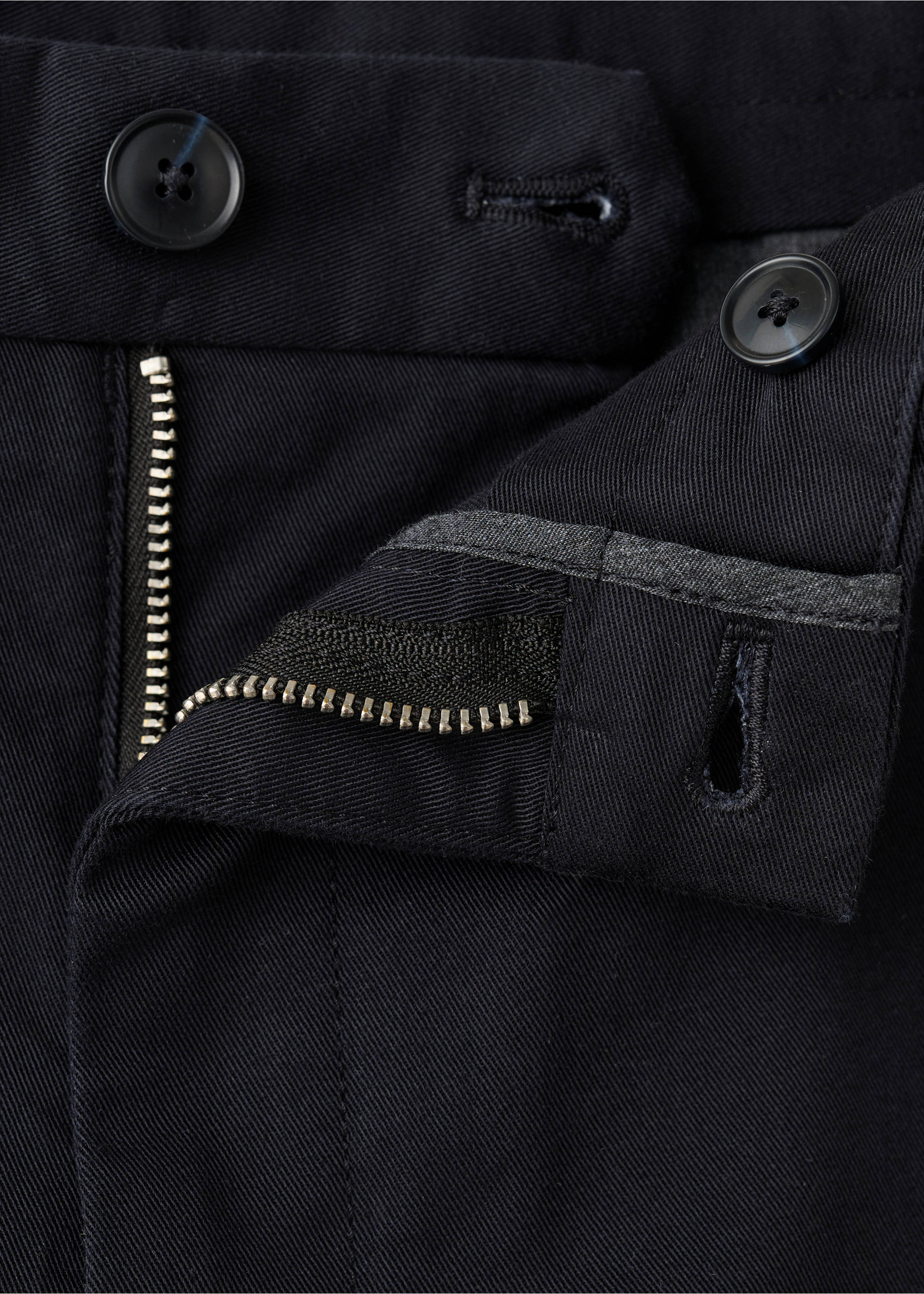 Close-up of dark blue trousers fabric, button fly, and waistband., Navy. Ref: 27041187-00.