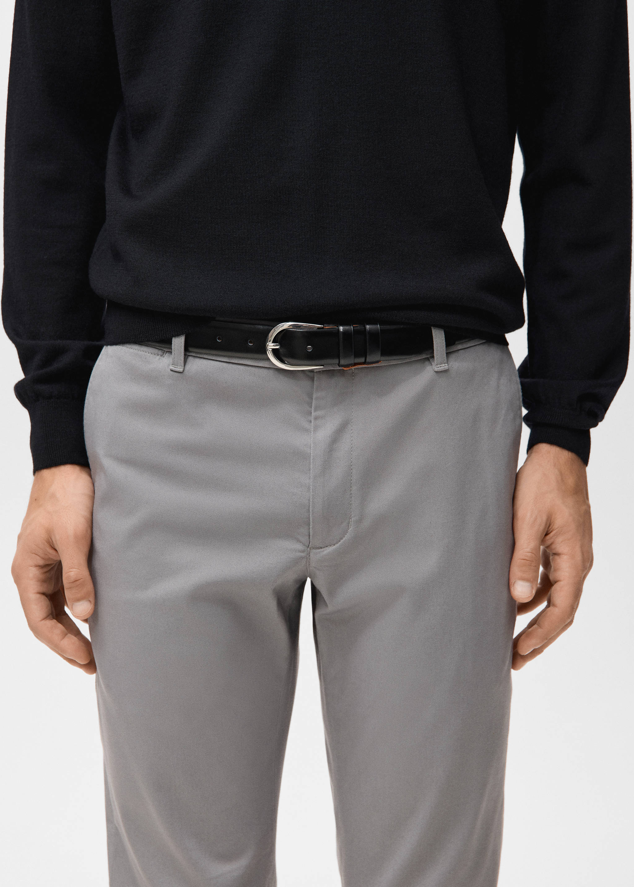 Grey trousers with a black leather belt