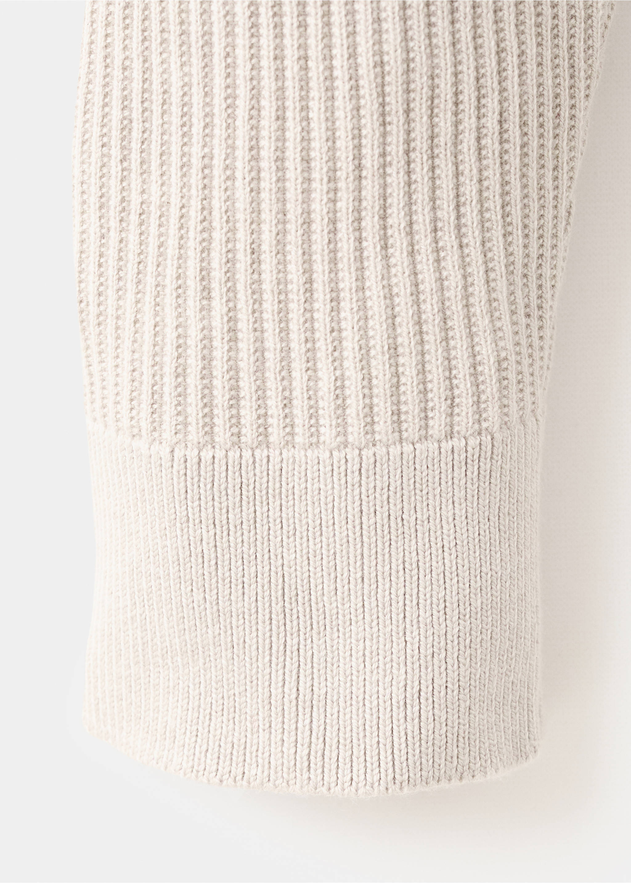 Close-up of the ribbed cuff and knit fabric of an off-white sweater., Beige. Ref: 27041283-00.
