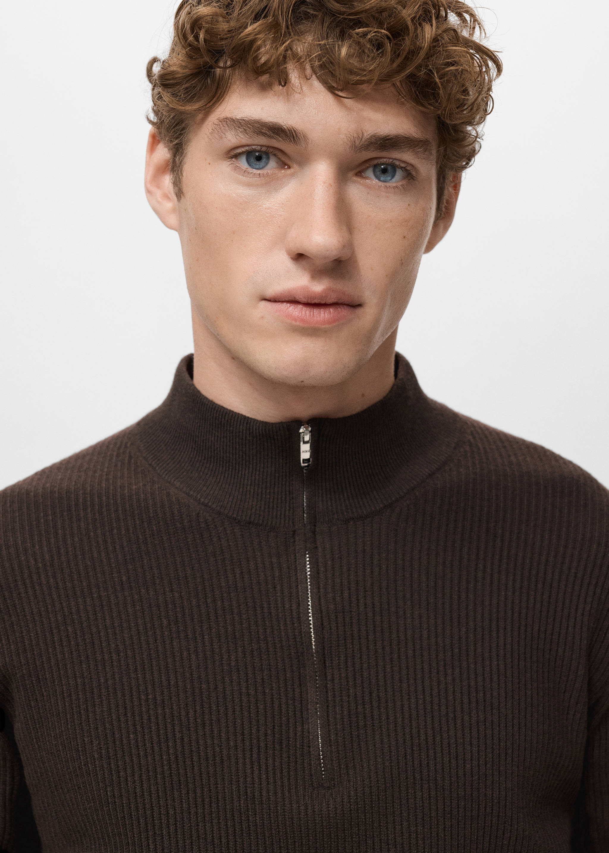 Dark brown ribbed knit jersey with a high zip-neck collar and half-zip.