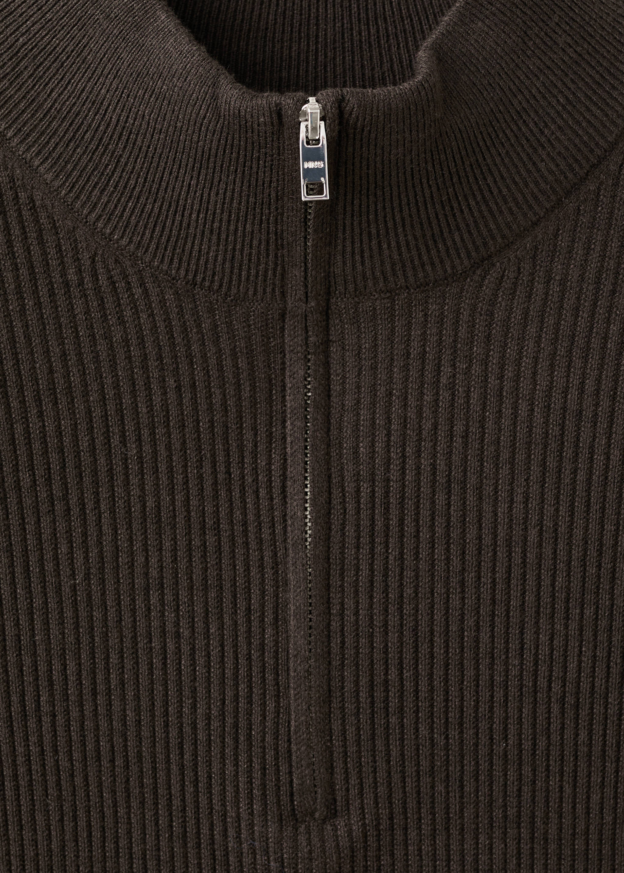 Close-up of a dark brown ribbed jersey with a half-zip high collar.