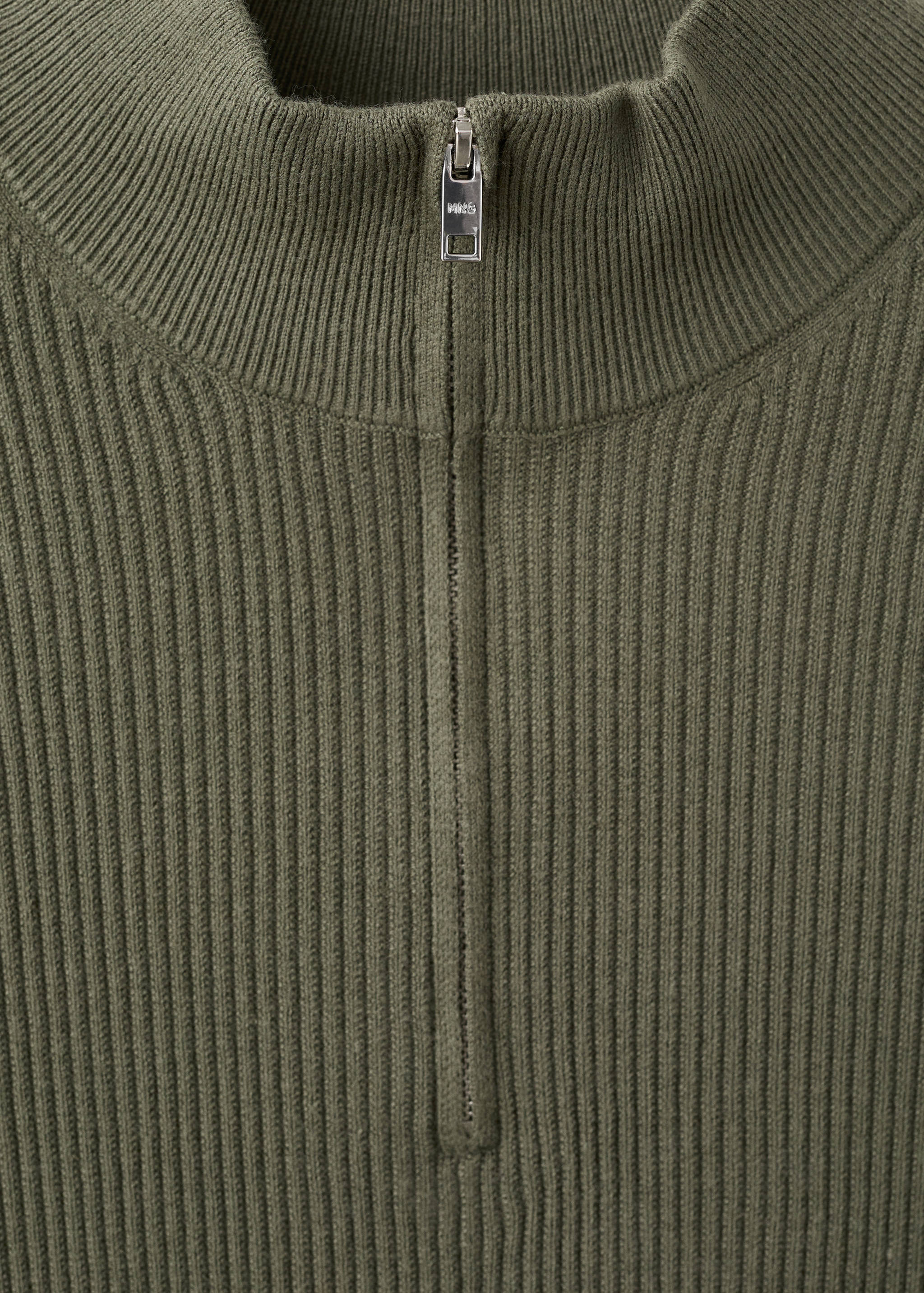 Olive green ribbed knit jersey detail with a high neck and half-zip.