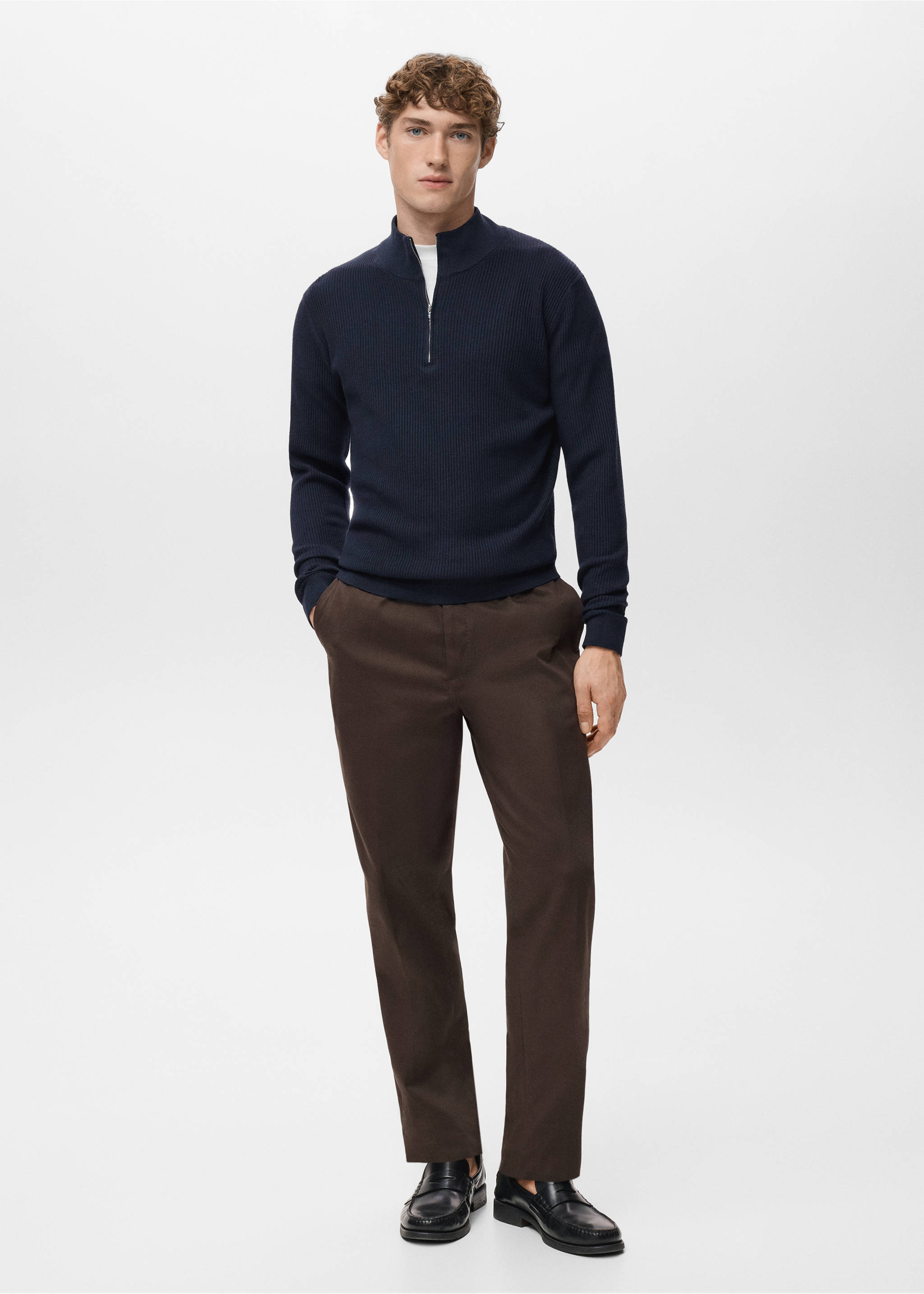 Navy blue knitted jersey with a high zip collar, worn with brown trousers., Navy. Ref: 27041283-00.