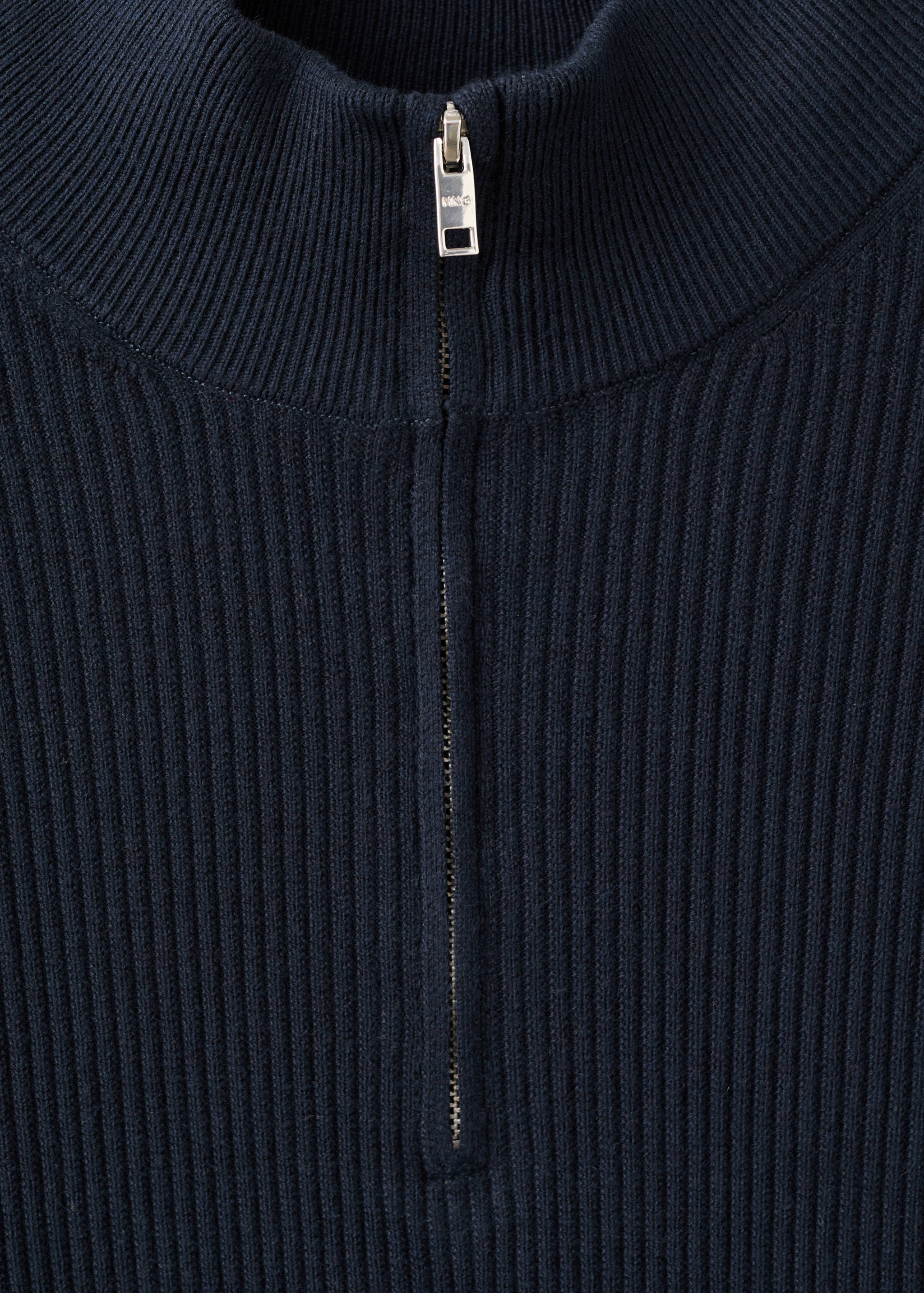 Navy blue ribbed jersey with a high zip-up neck detail.