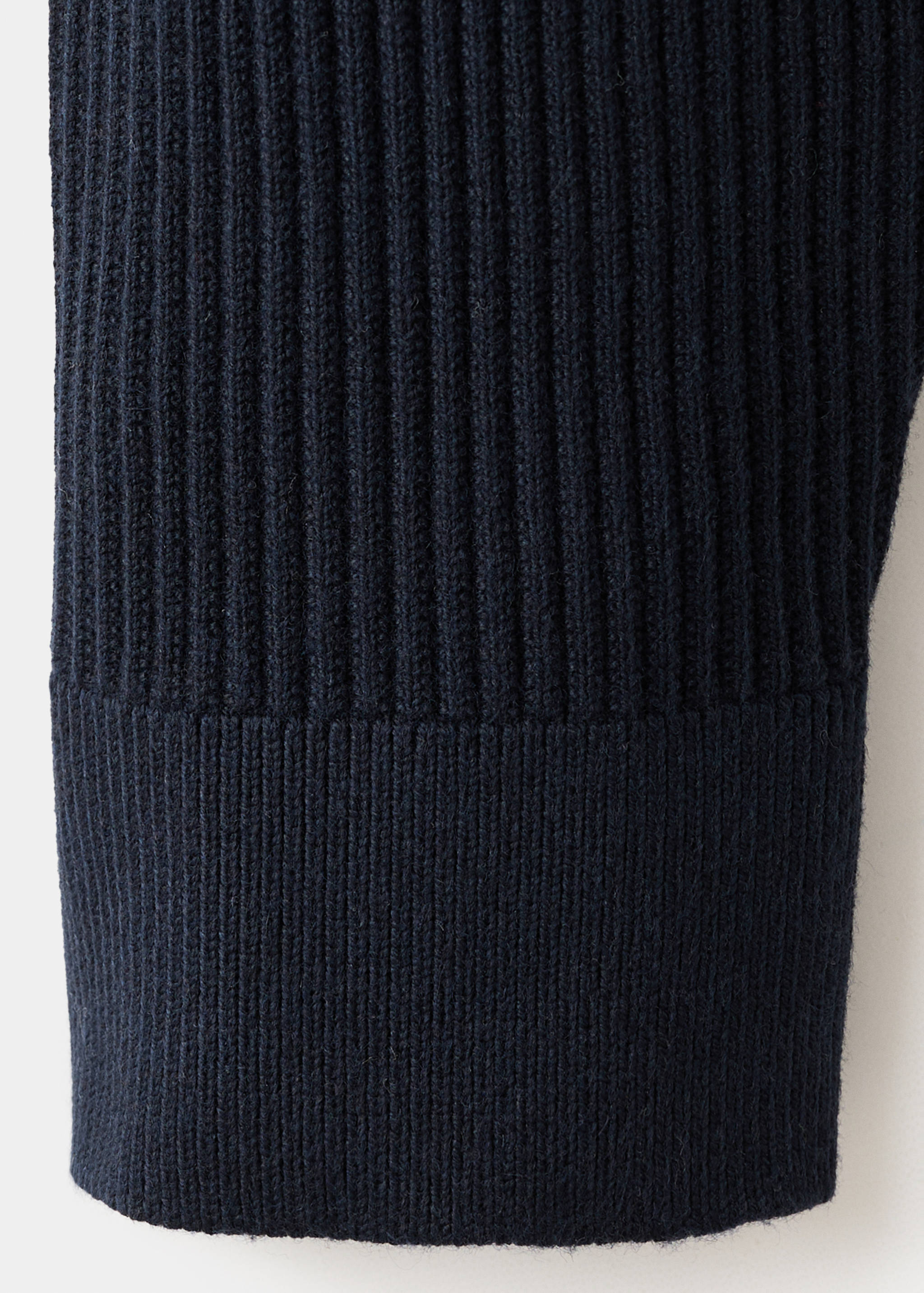 Close-up of navy blue men's knitted jersey fabric and cuff.