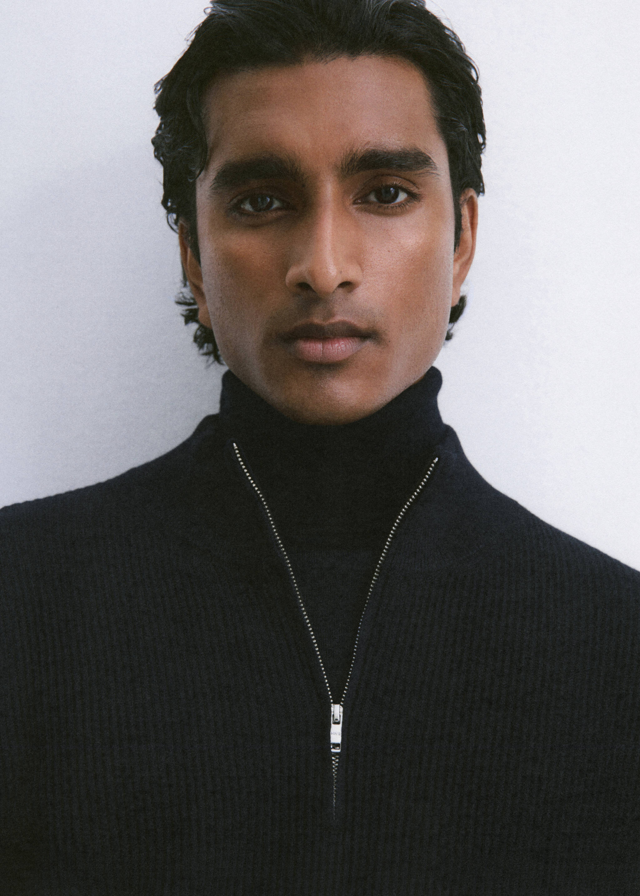 Dark navy blue ribbed jersey with a high neck and zip collar.