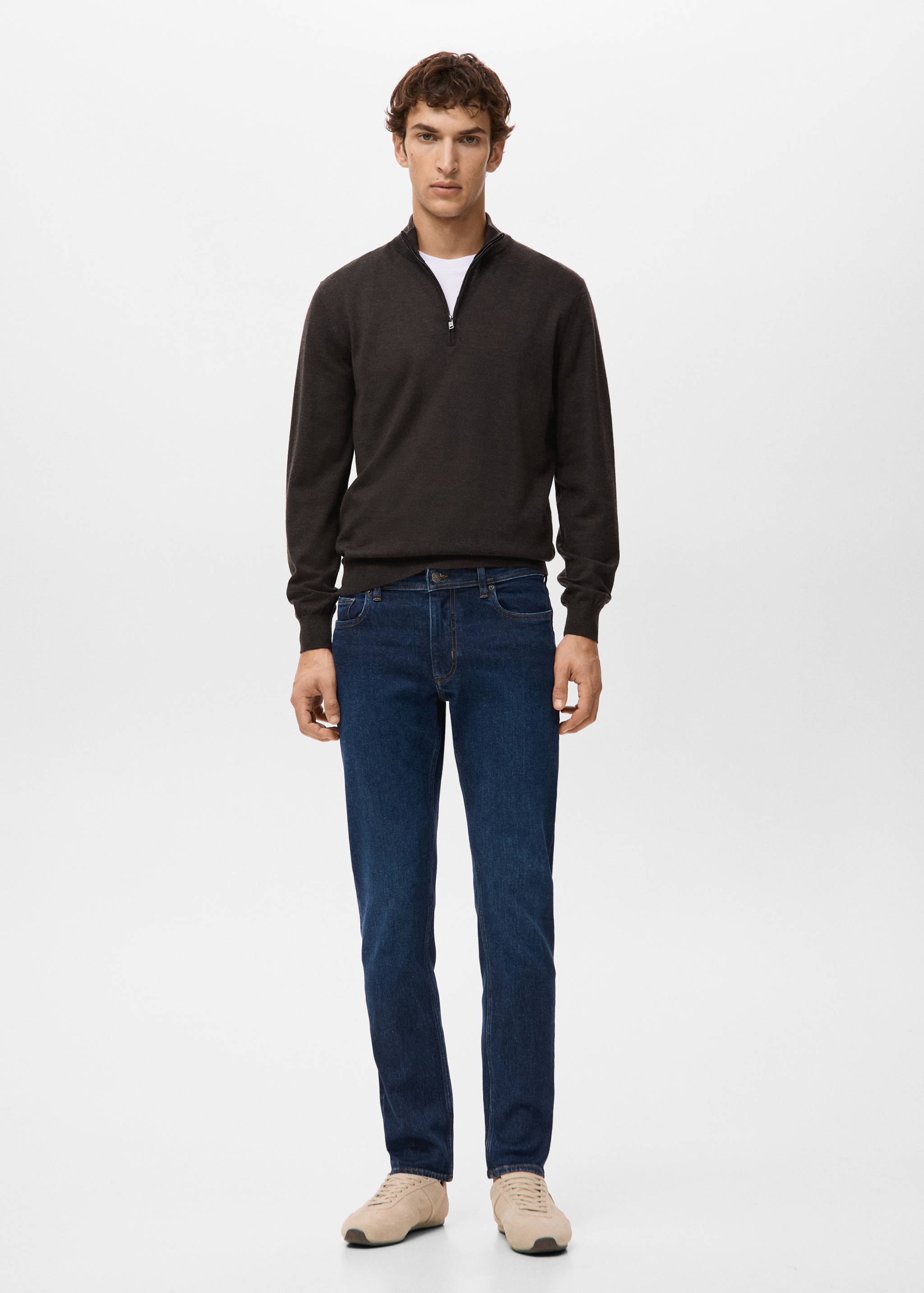 Dark brown zip-neck jersey worn with blue jeans.
