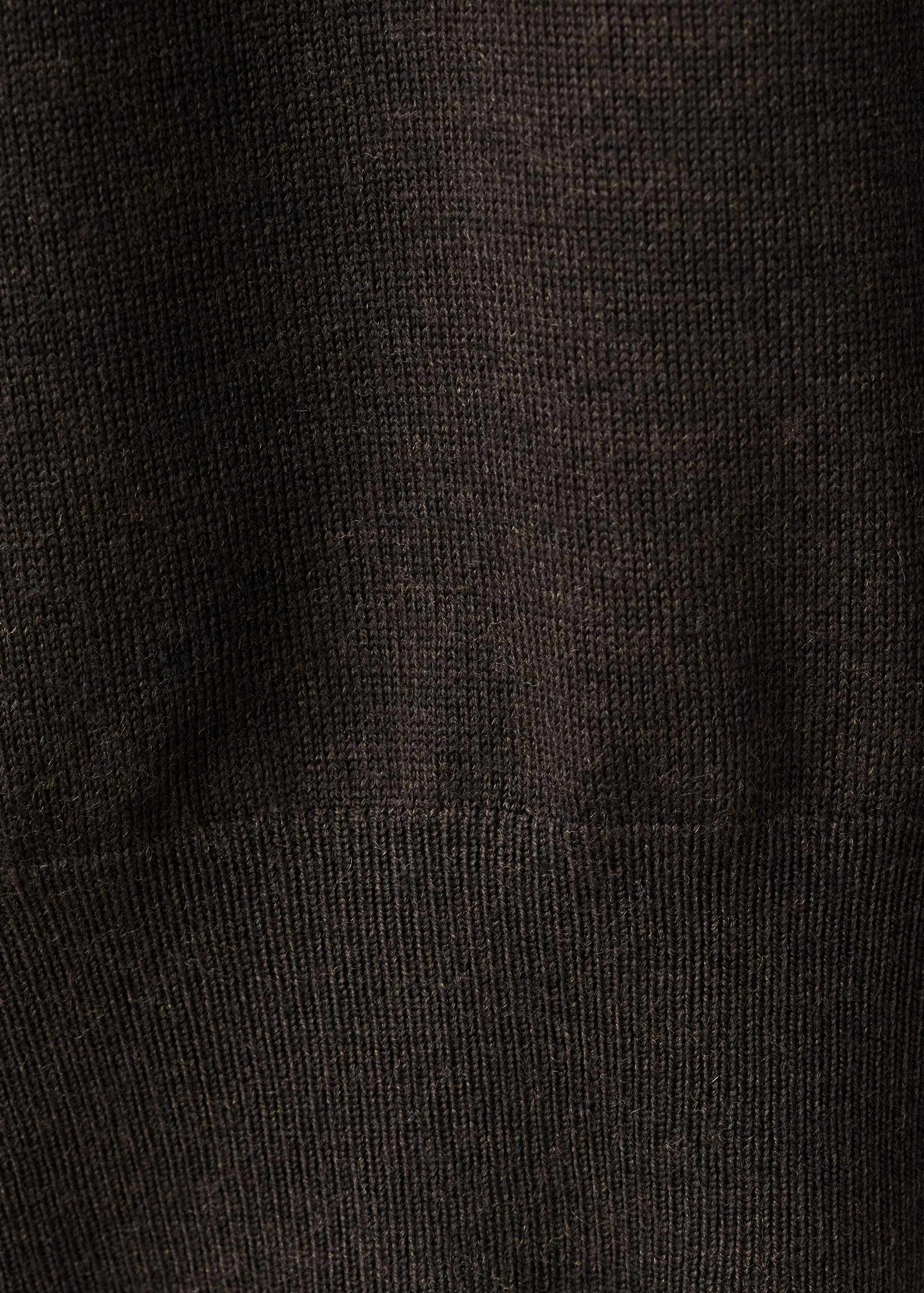 Dark brown knit sweater fabric close-up.