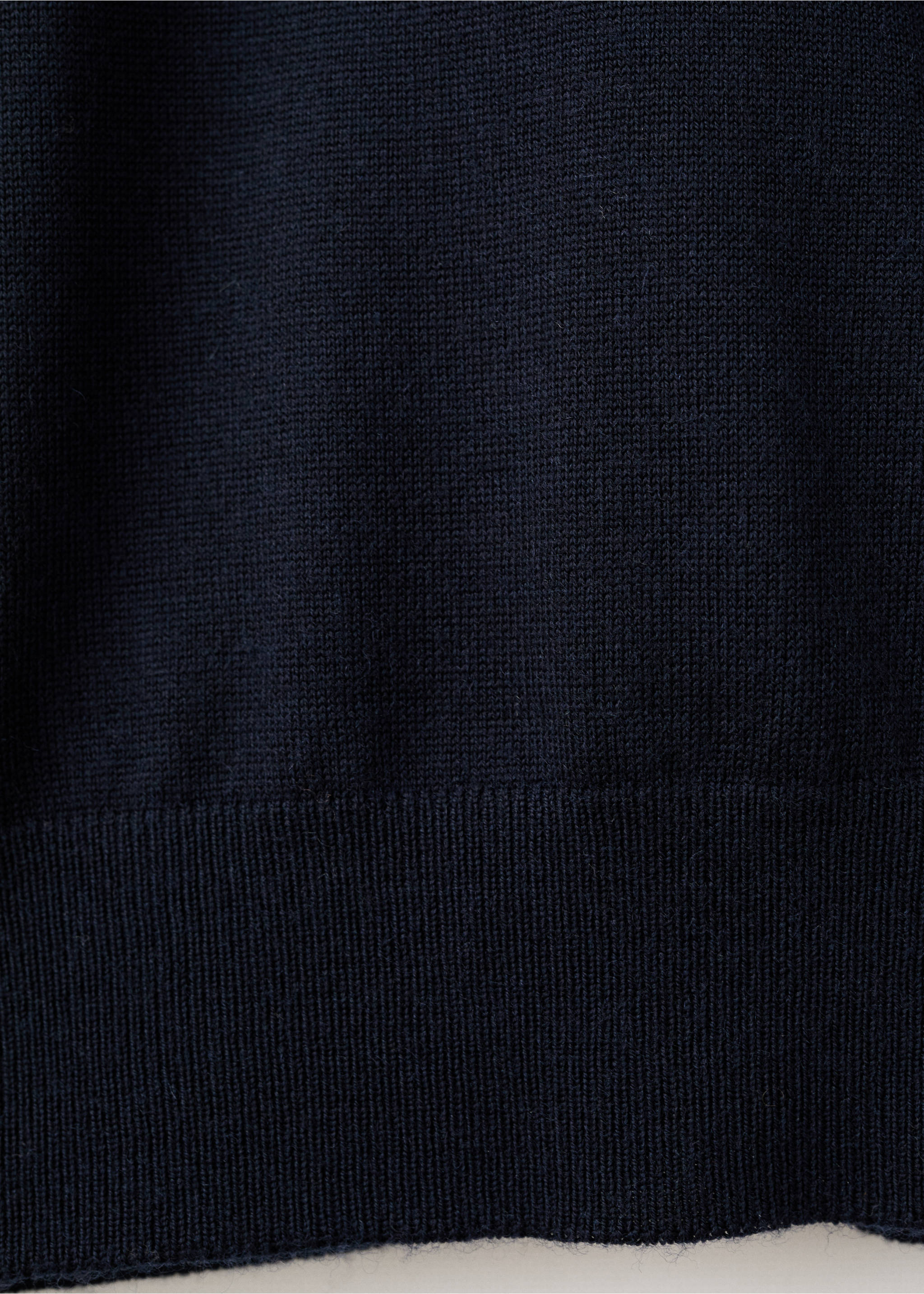 Close-up of a dark navy blue fine-knit jersey showing the knit texture and ribbed hem., Navy. Ref: 27041285-00.