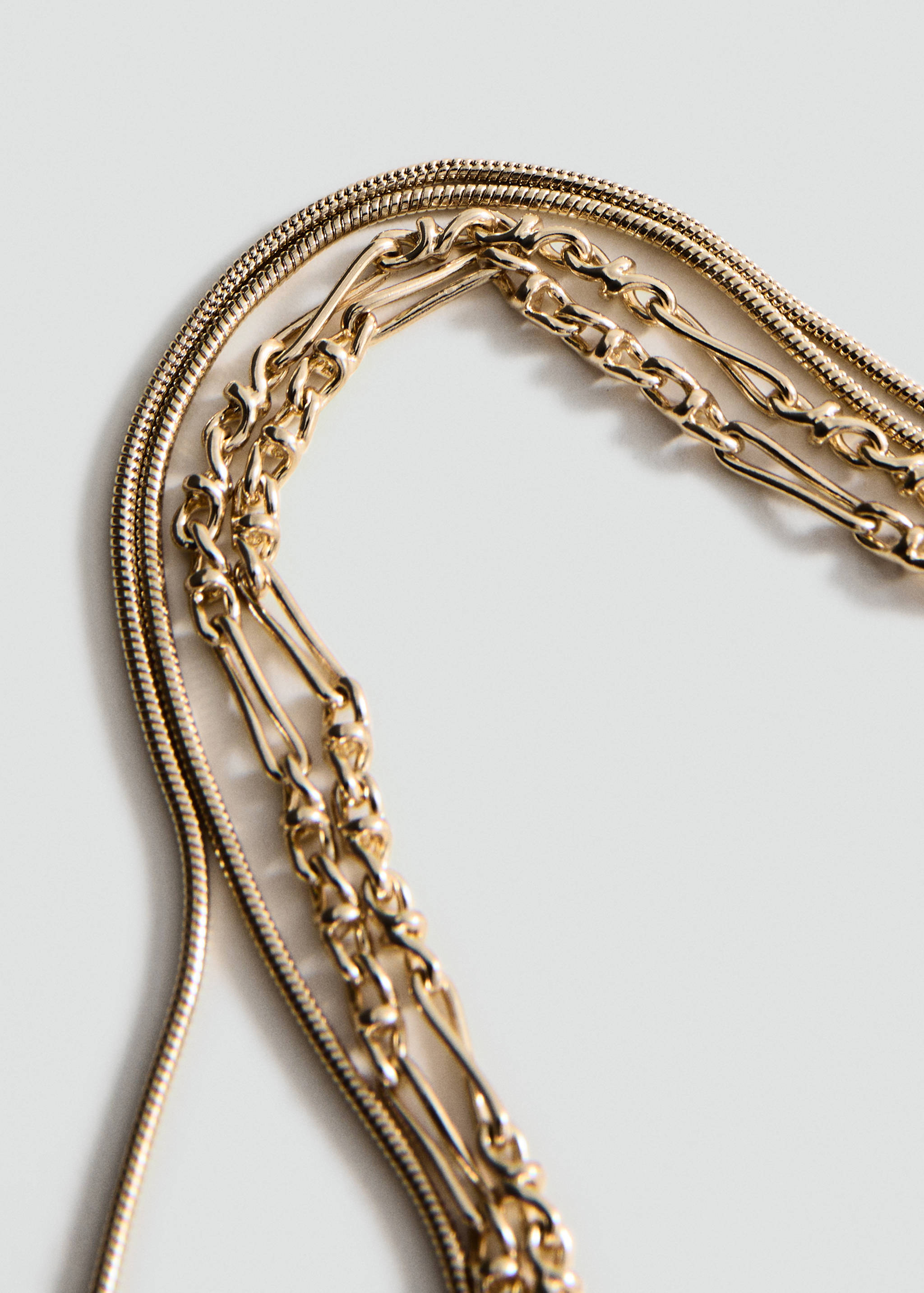 Multi-strand gold-tone collar necklace with varied chain designs.