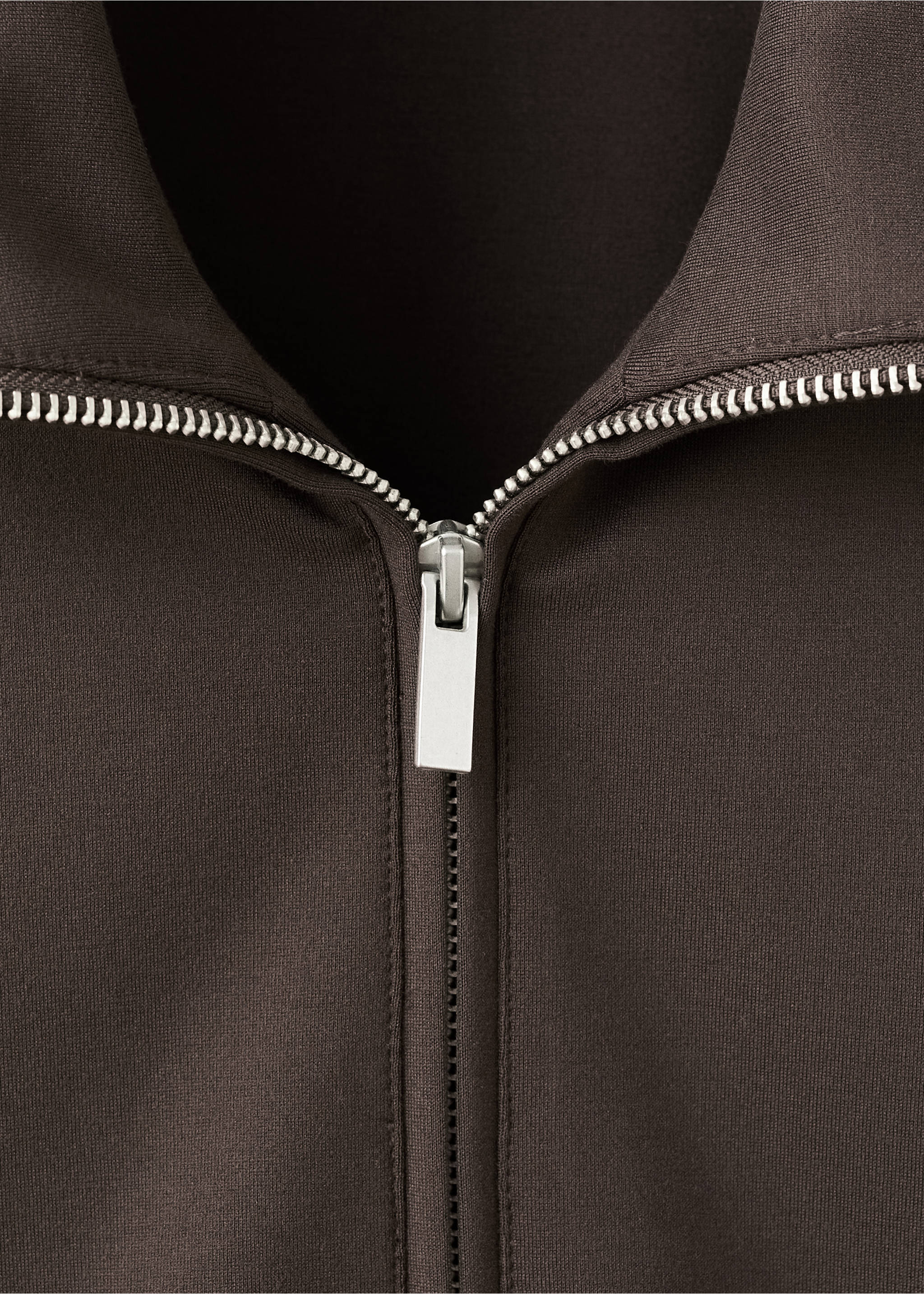 Close-up of a brown sweatshirt featuring a high collar and silver zip., Brown. Ref: 27043306-00.