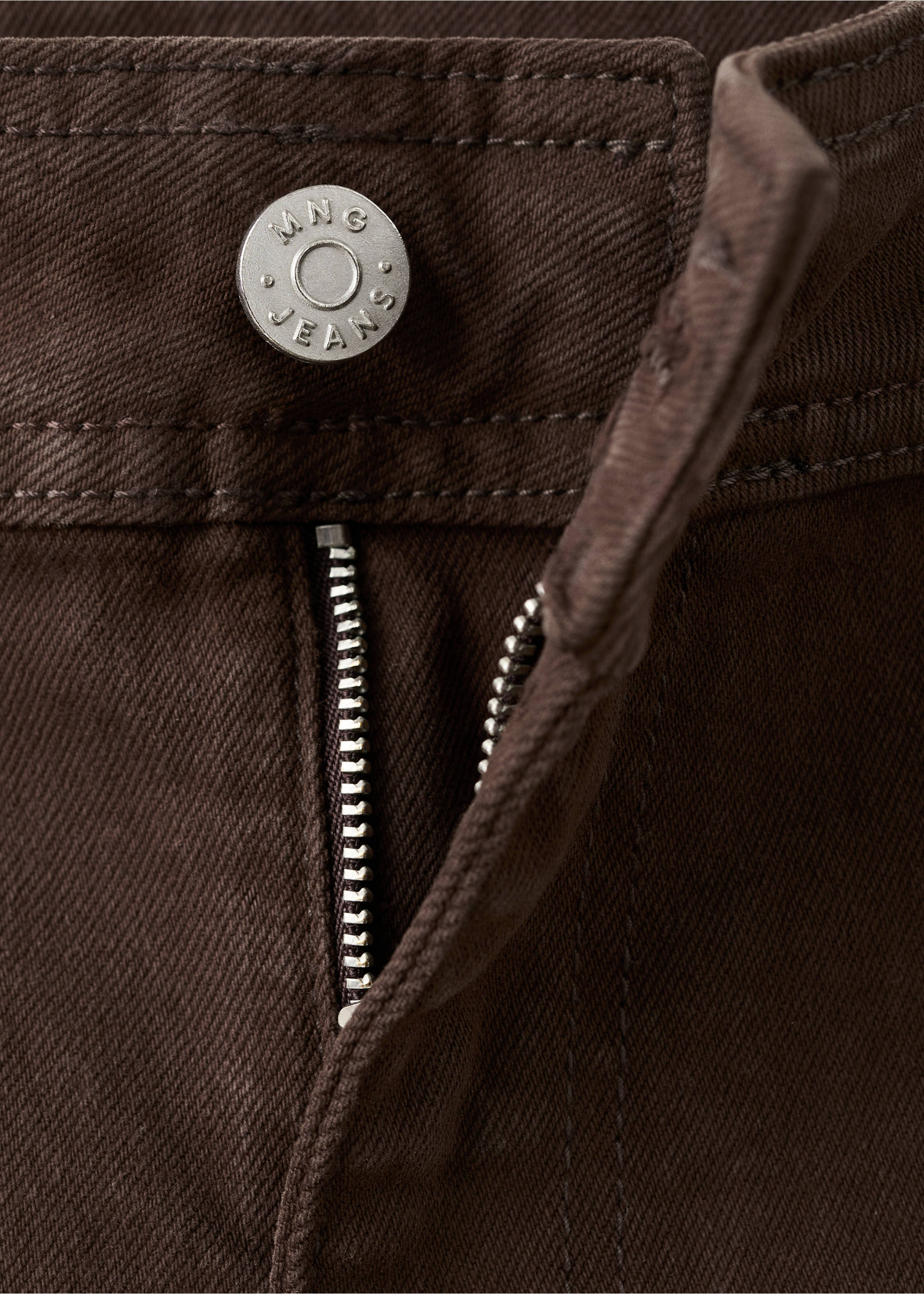 Close-up of brown denim trousers showing the branded button and zip fly., Chocolate. Ref: 27043342-00.