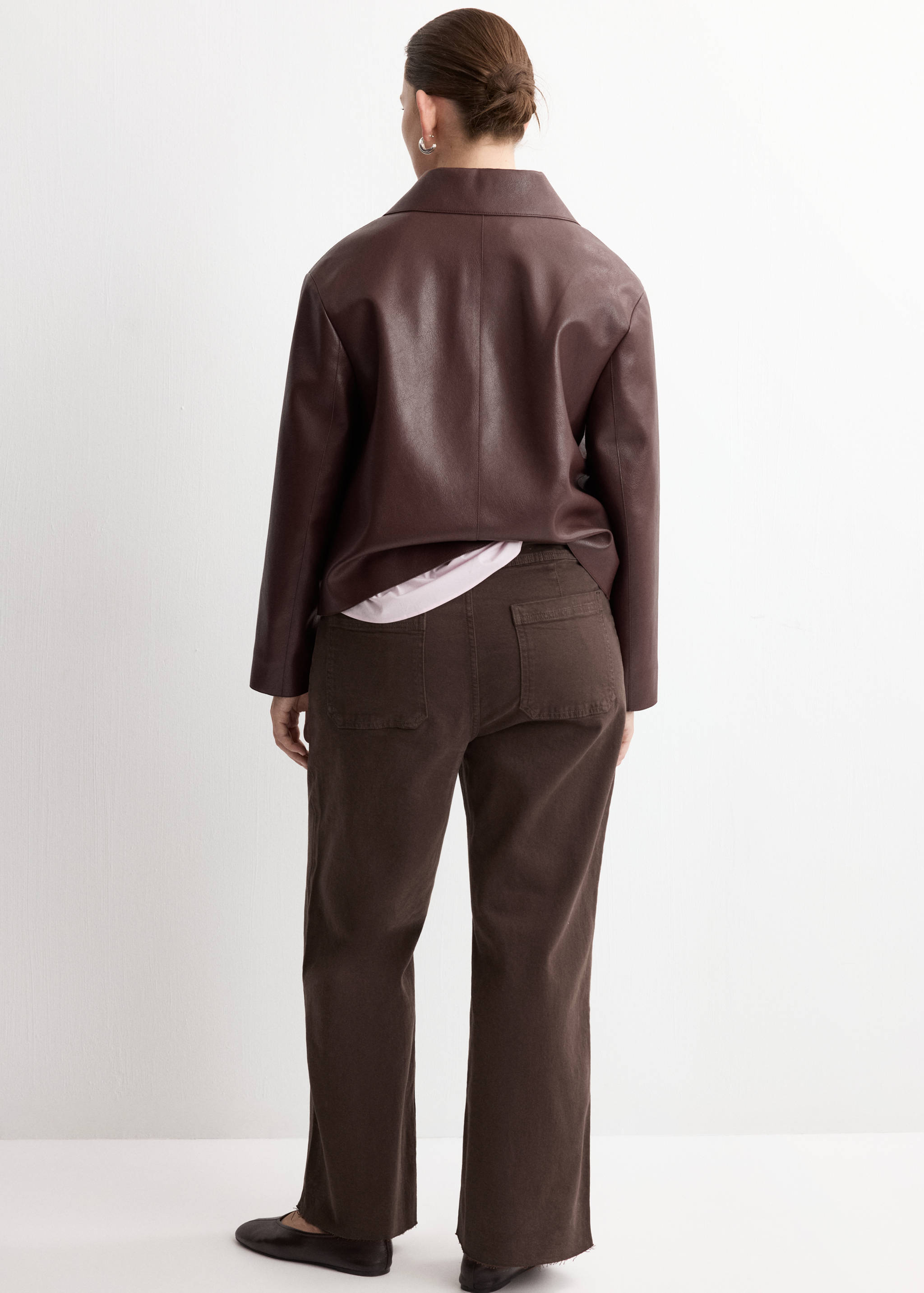 Dark brown straight-leg jeans with back pockets, seen from behind.