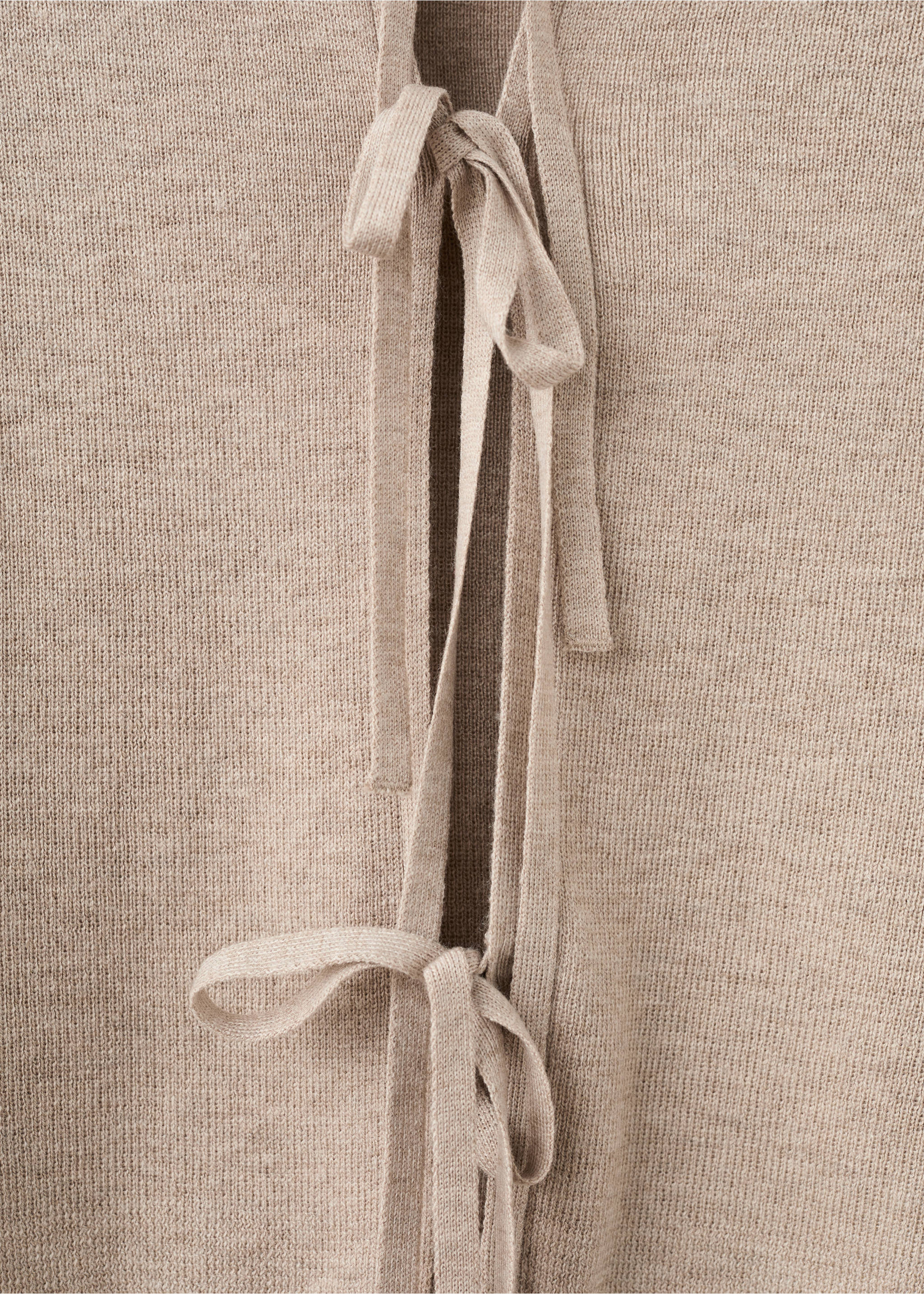 Close-up of a beige knit cardigan featuring thin front tie closures., Sand. Ref: 27044048-00.