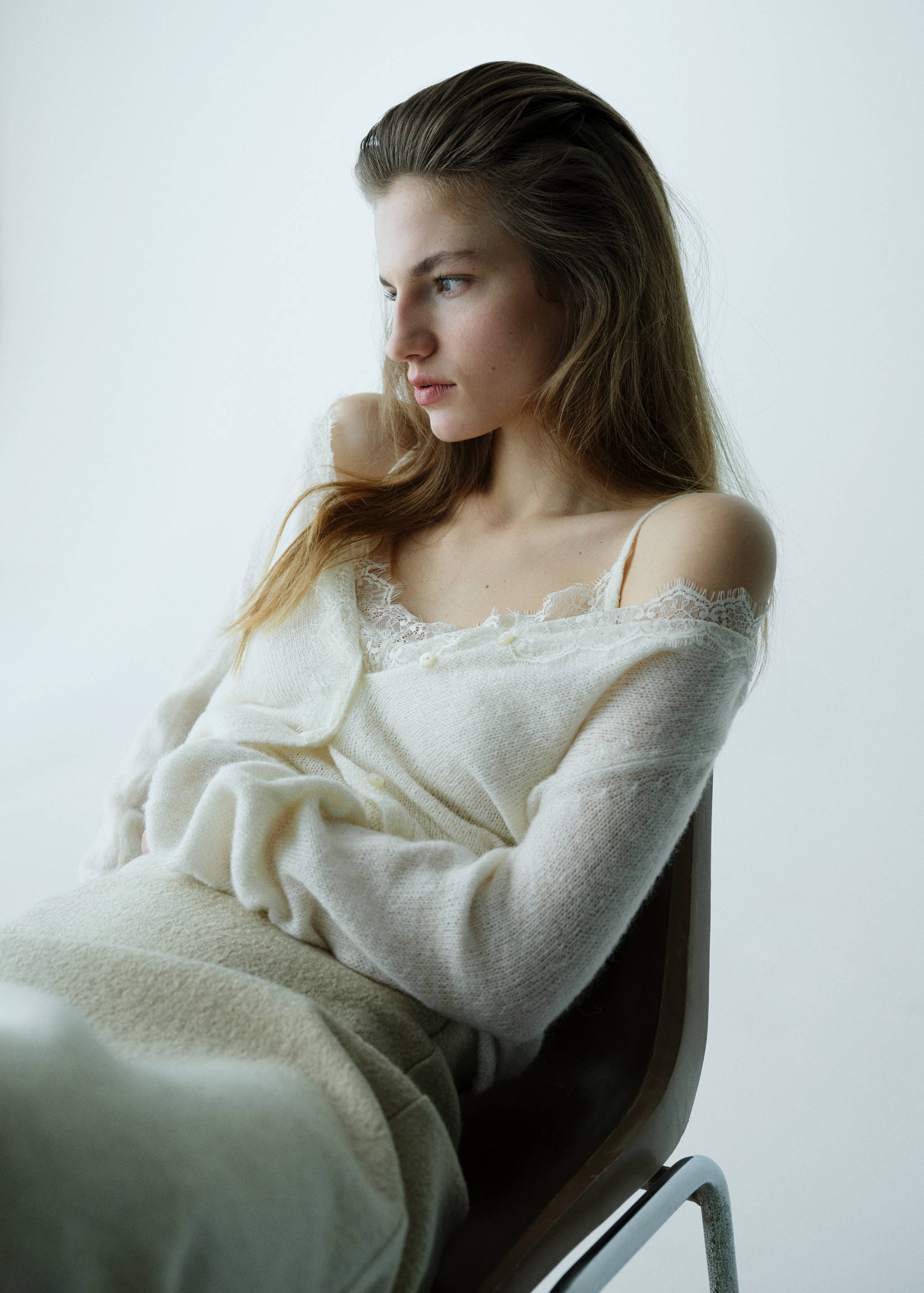 Cream-coloured fuzzy knit top with delicate lace trim.