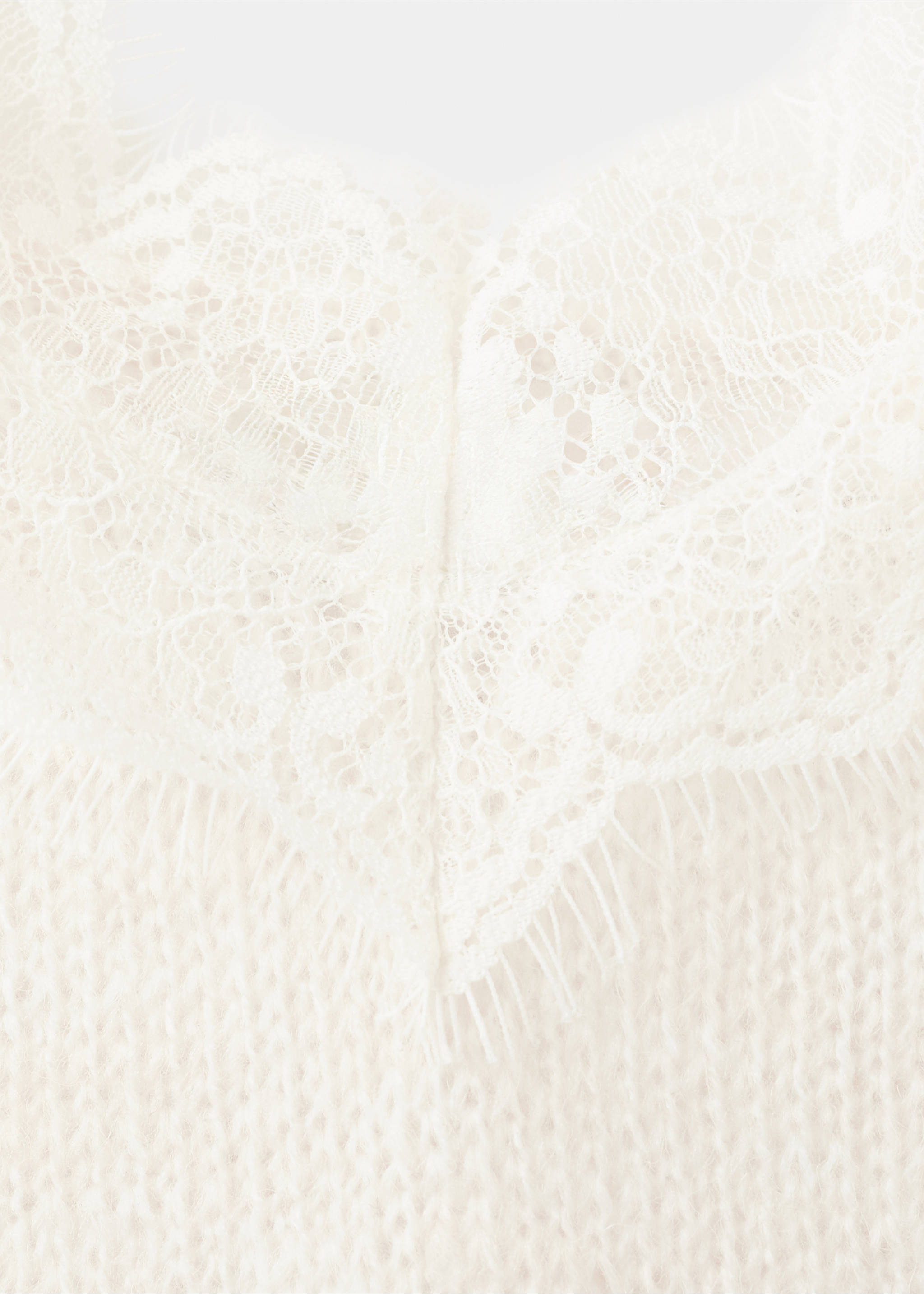 Close-up of cream knit top featuring a V-neckline with lace trim., Ecru. Ref: 27044097-00.