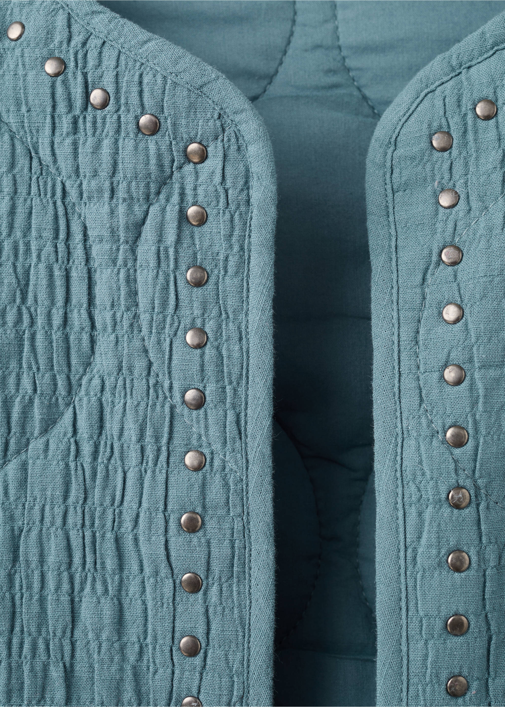 Close-up of a teal quilted jacket with metallic stud details., Petrol Blue. Ref: 27045156-00.