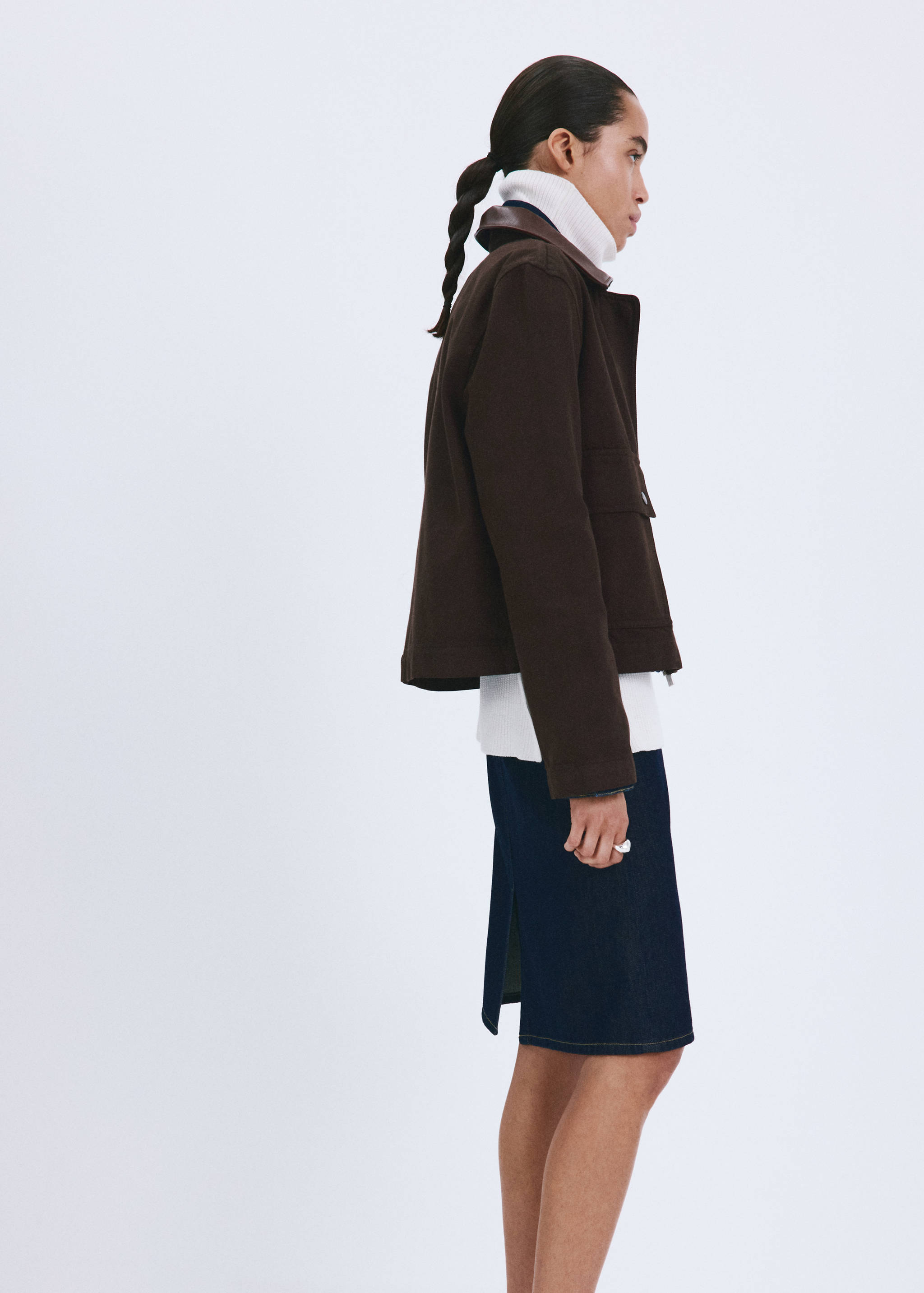 Brown cropped jacket with a contrasting collar and chest pocket, side view.