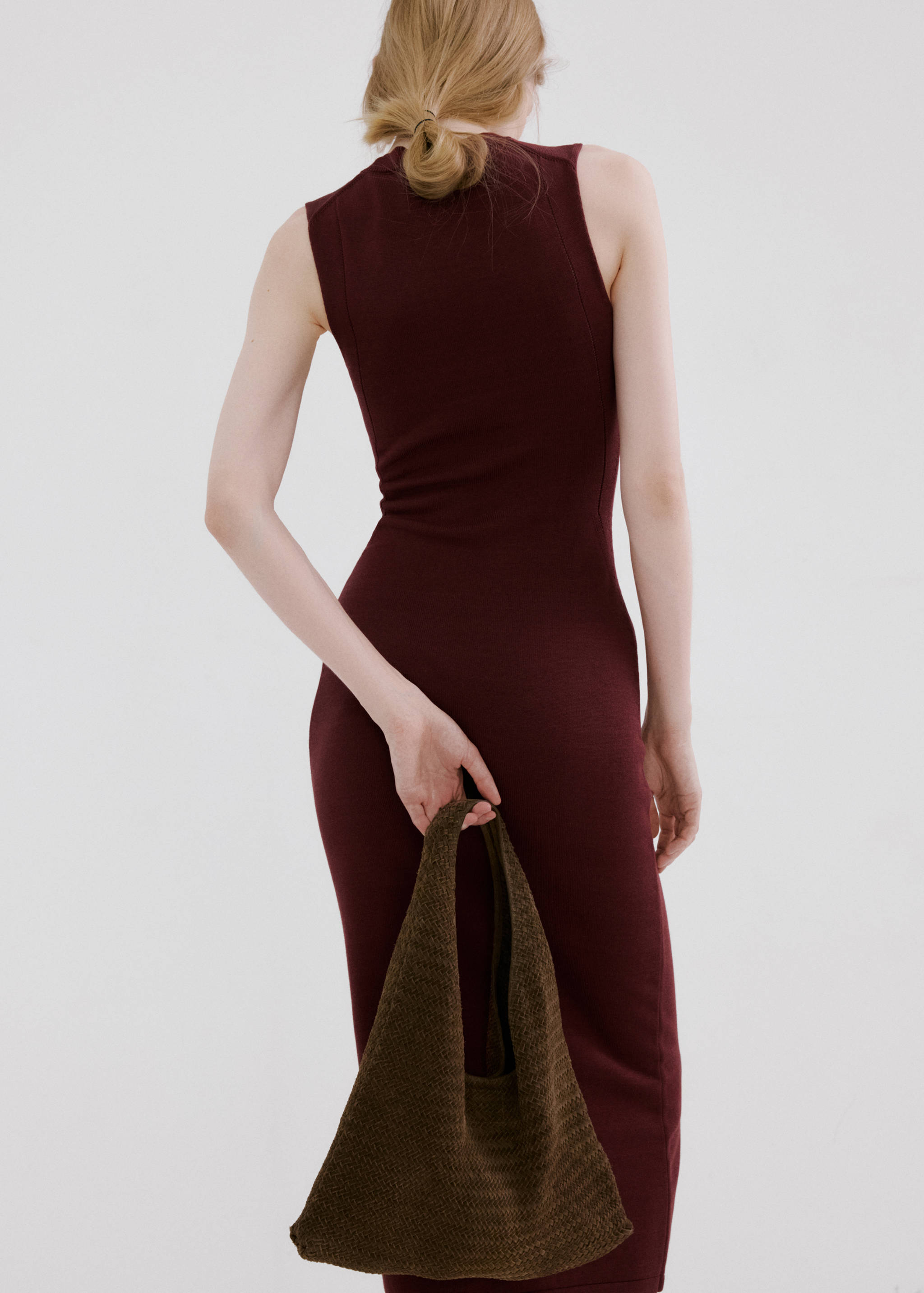 Back view of a dark burgundy sleeveless fitted knit dress.