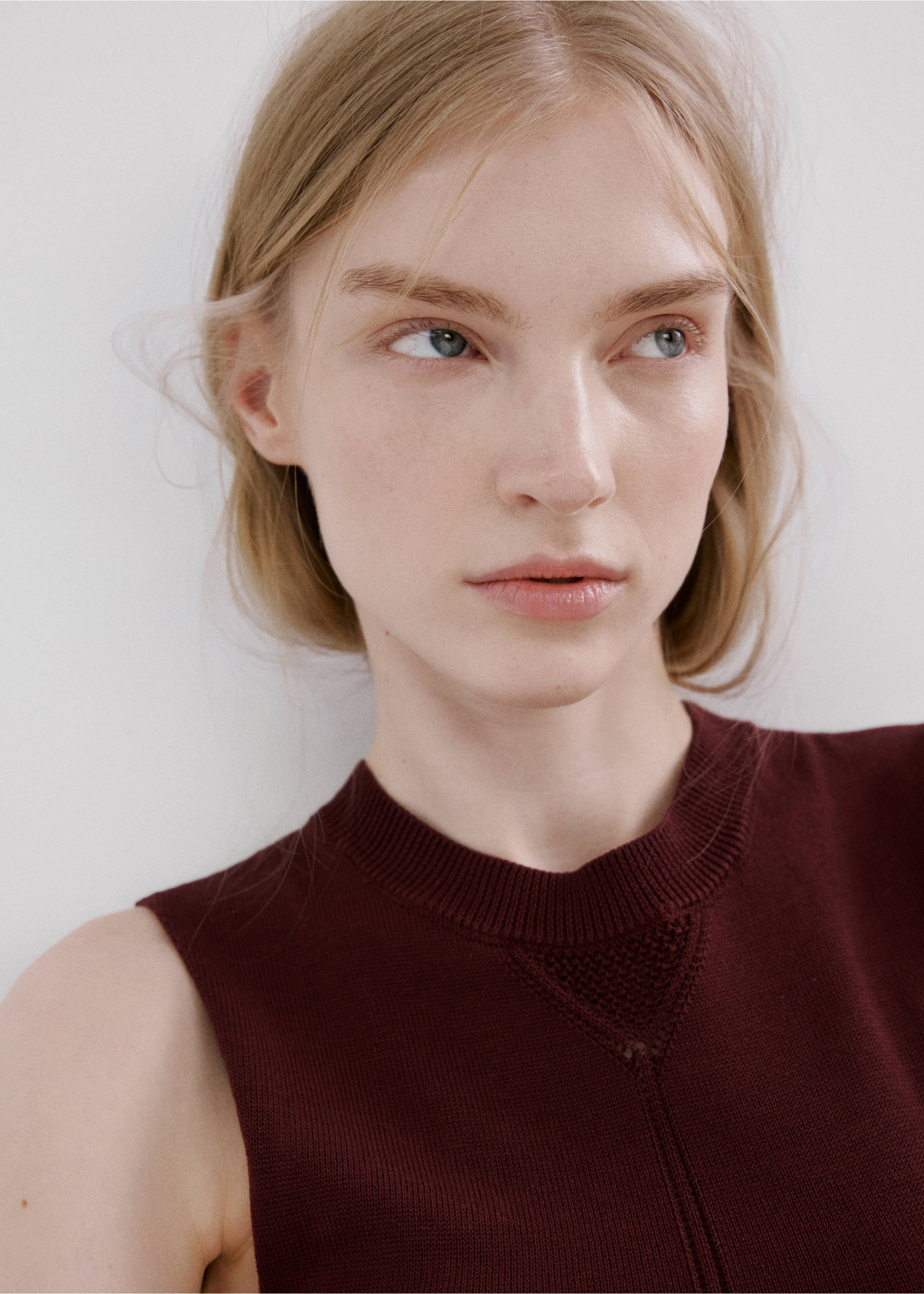 Close-up of a burgundy knit dress with a round ribbed neckline., Wine. Ref: 27045824-00.