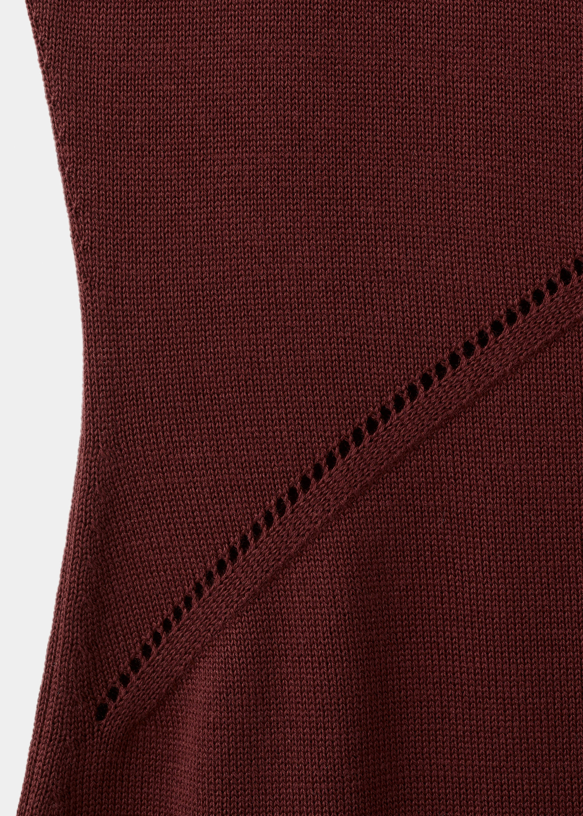 Burgundy knit dress fabric detail showing a diagonal open-work stitch.