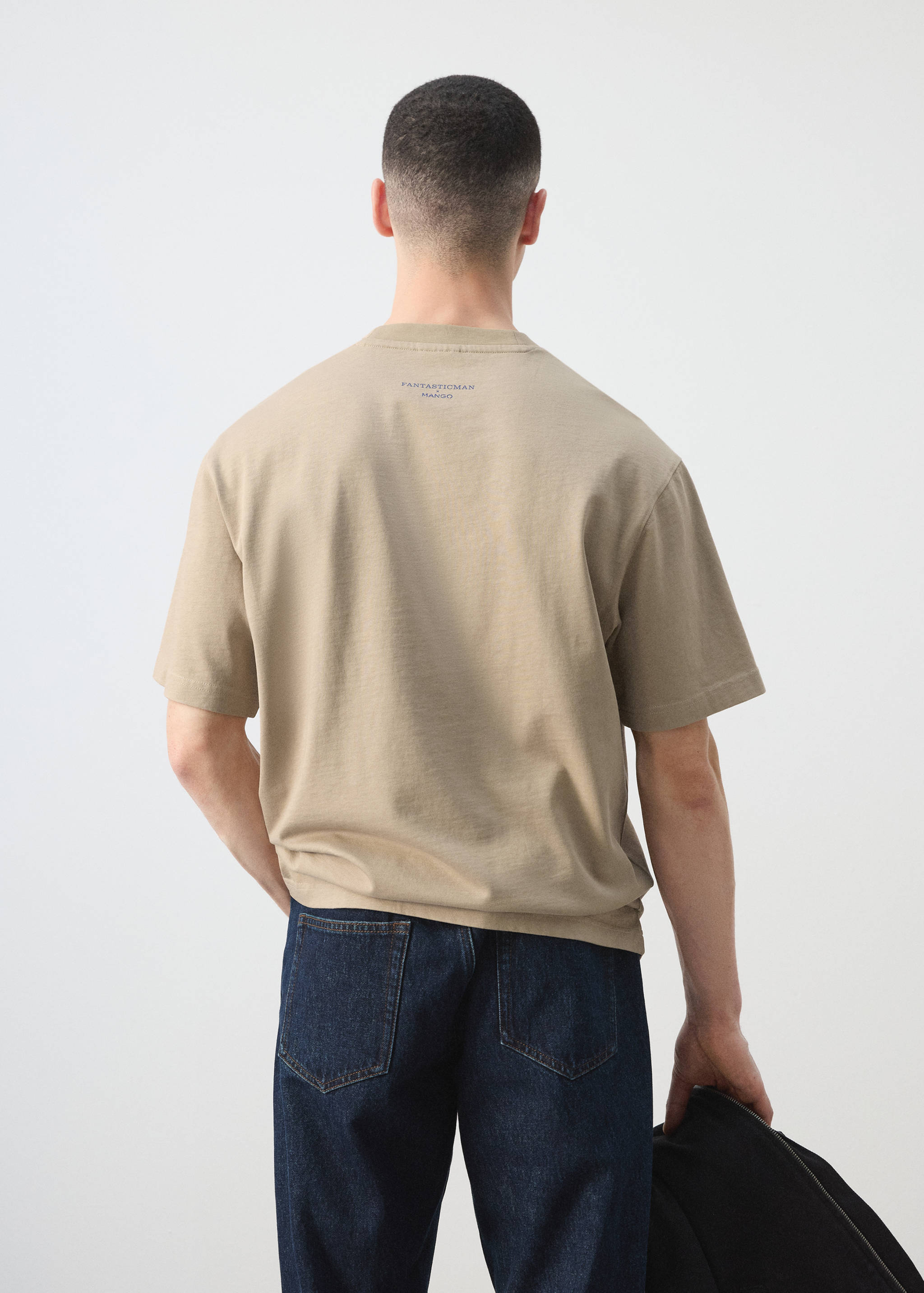 Beige short-sleeved T-shirt with back print, shown from the back.