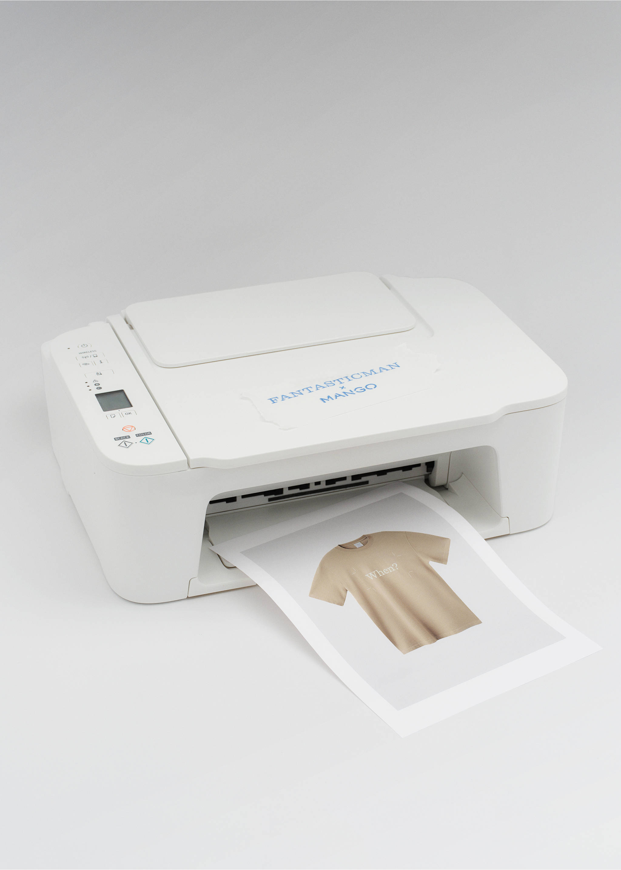 Beige short-sleeved t-shirt printed on a sheet of paper emerging from a white printer., Beige. Ref: 27045990-00.