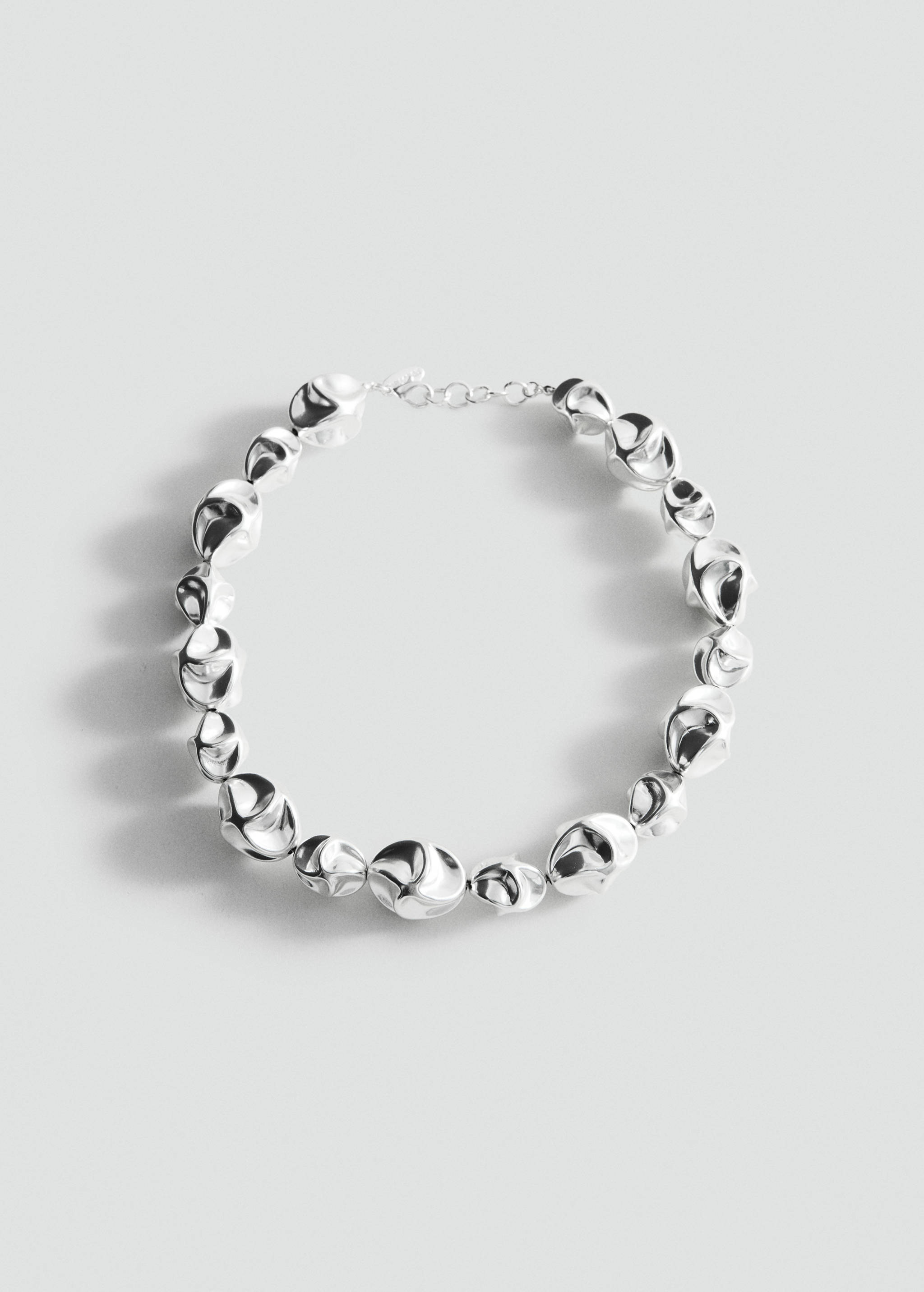 Silver metallic collar necklace with irregular organic links.