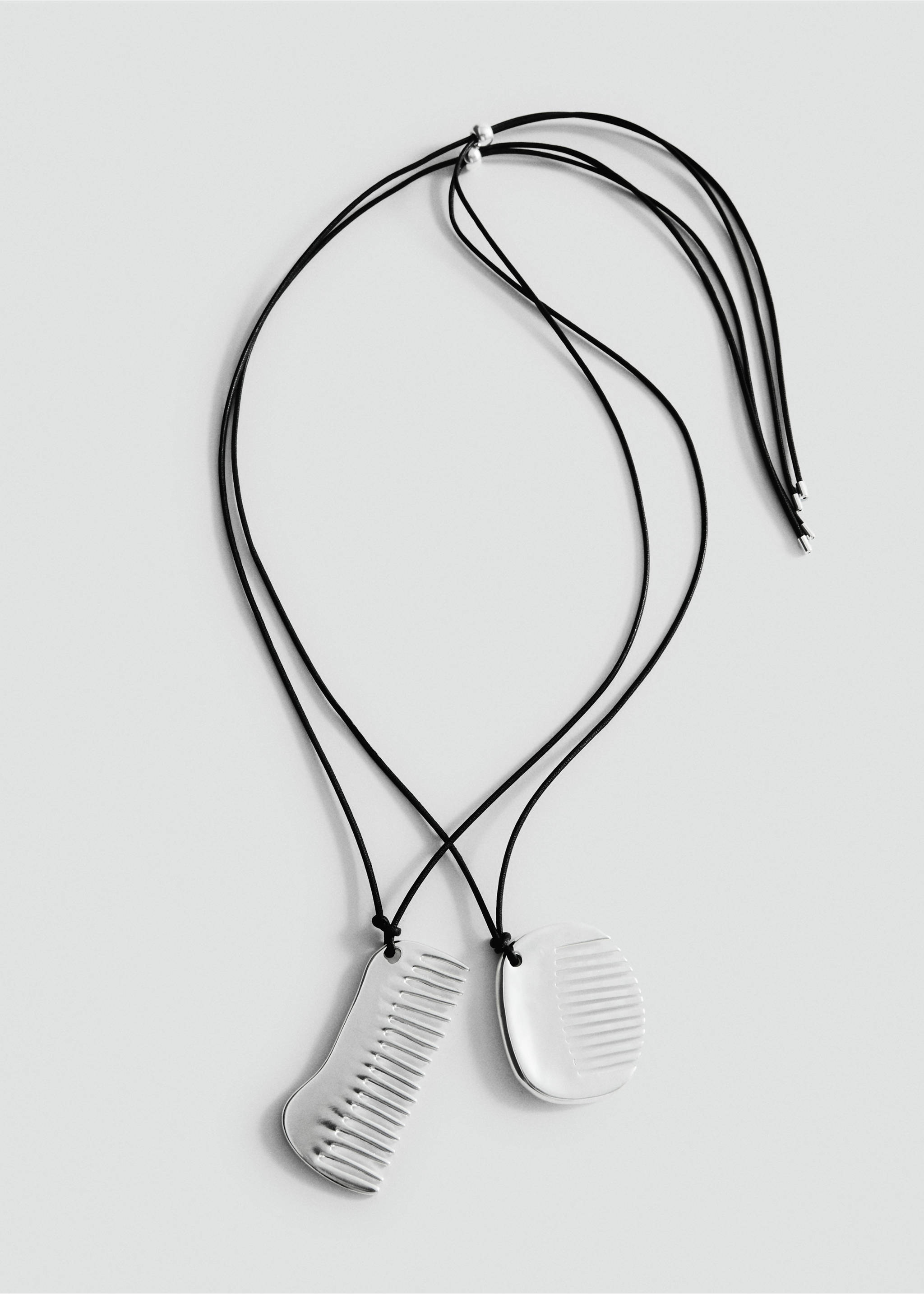 Silver-coloured metal comb pendant necklace on black cords., Silver. Ref: 27047799-00.