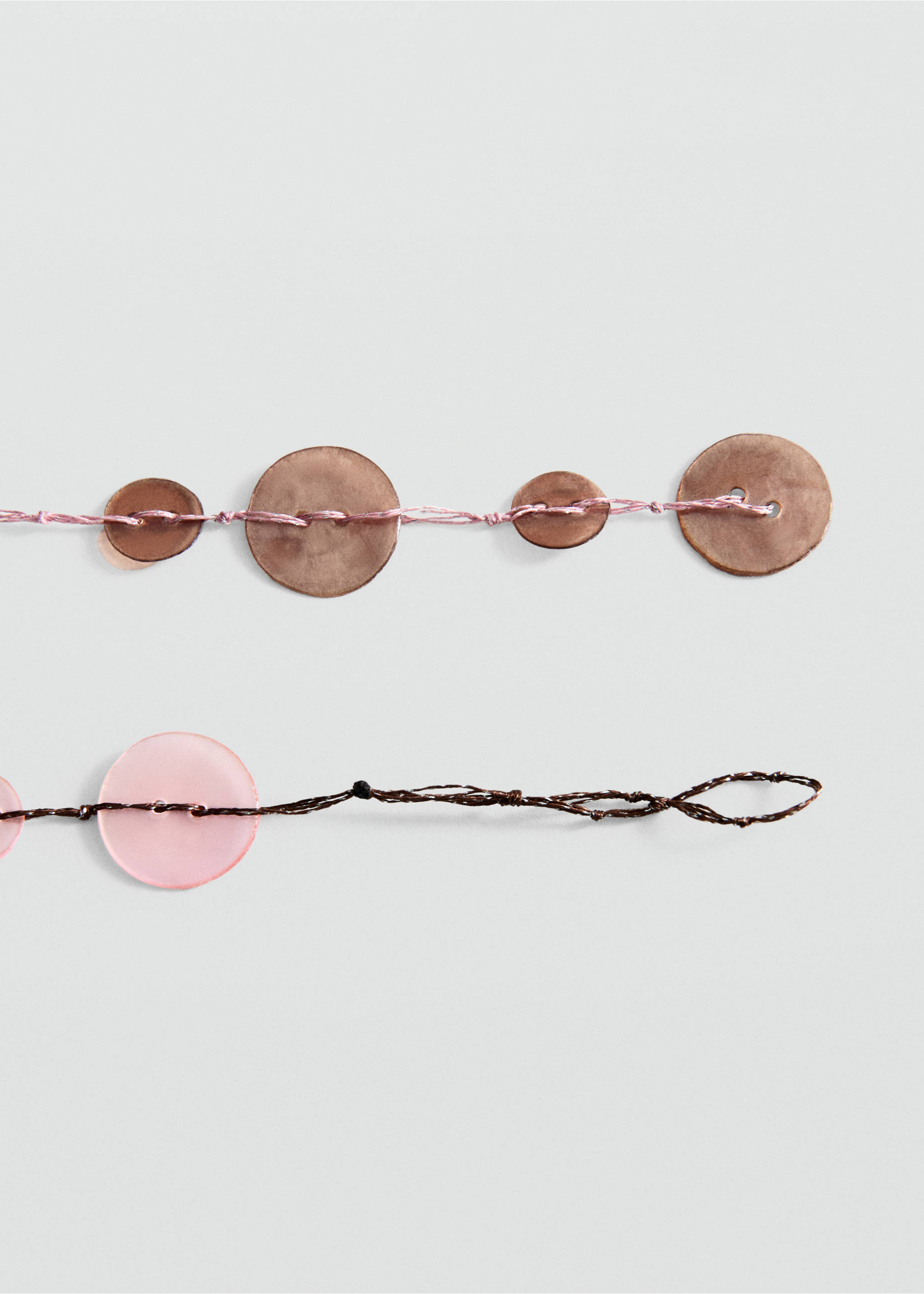 Close-up of a beaded collar accessory with threads and circular pieces., Pastel Pink. Ref: 27048658-00.