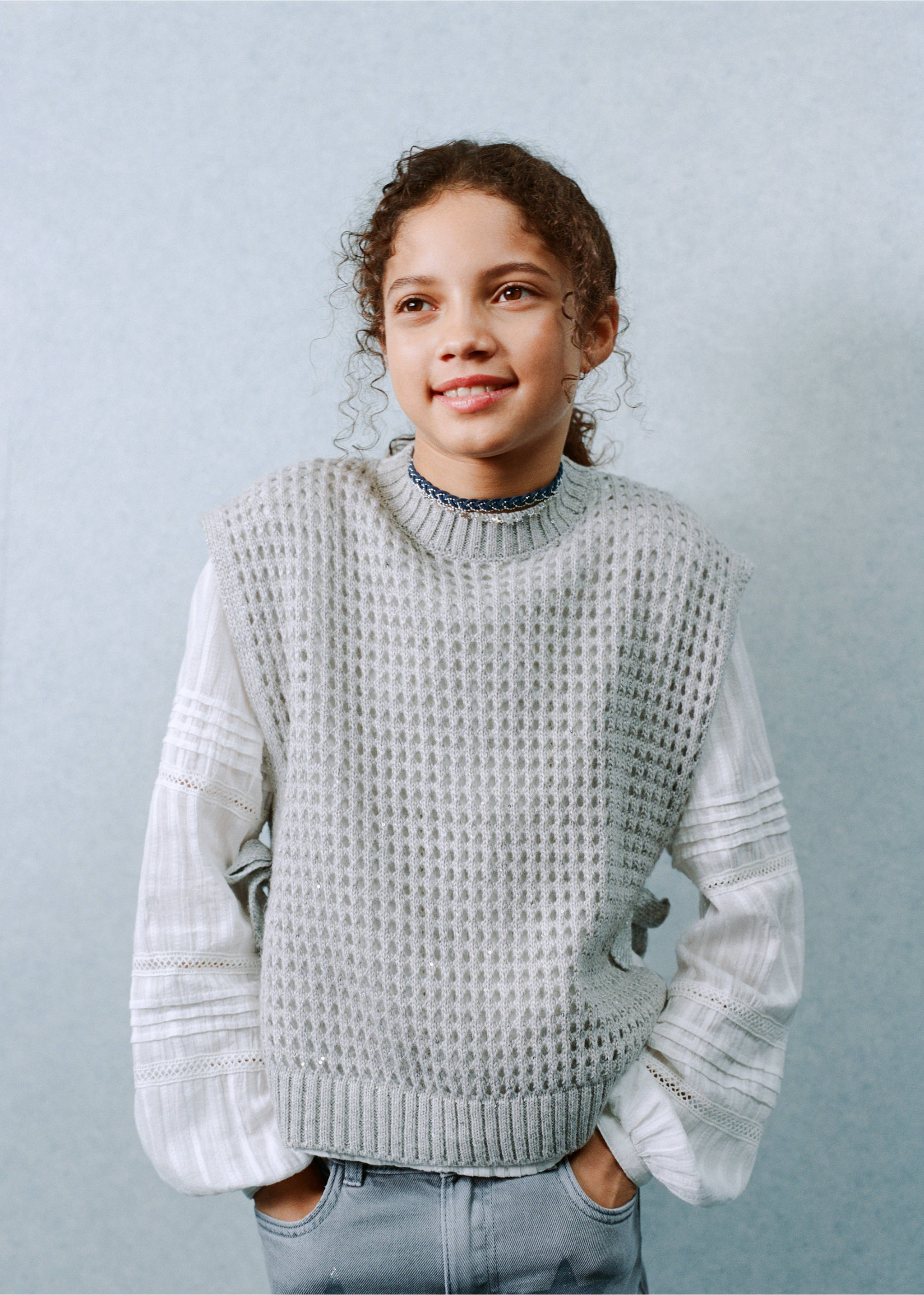 Grey knitted vest with a textured pattern, layered over a white blouse., Light/Pastel Grey. Ref: 27051180-00.