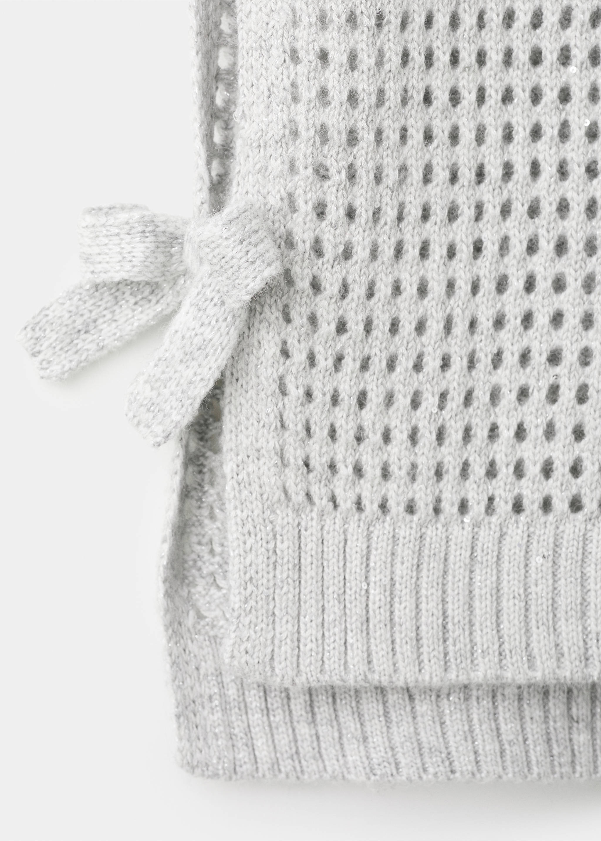 Close-up of a grey knitted vest with mesh texture and side bow., Light/Pastel Grey. Ref: 27051180-00.