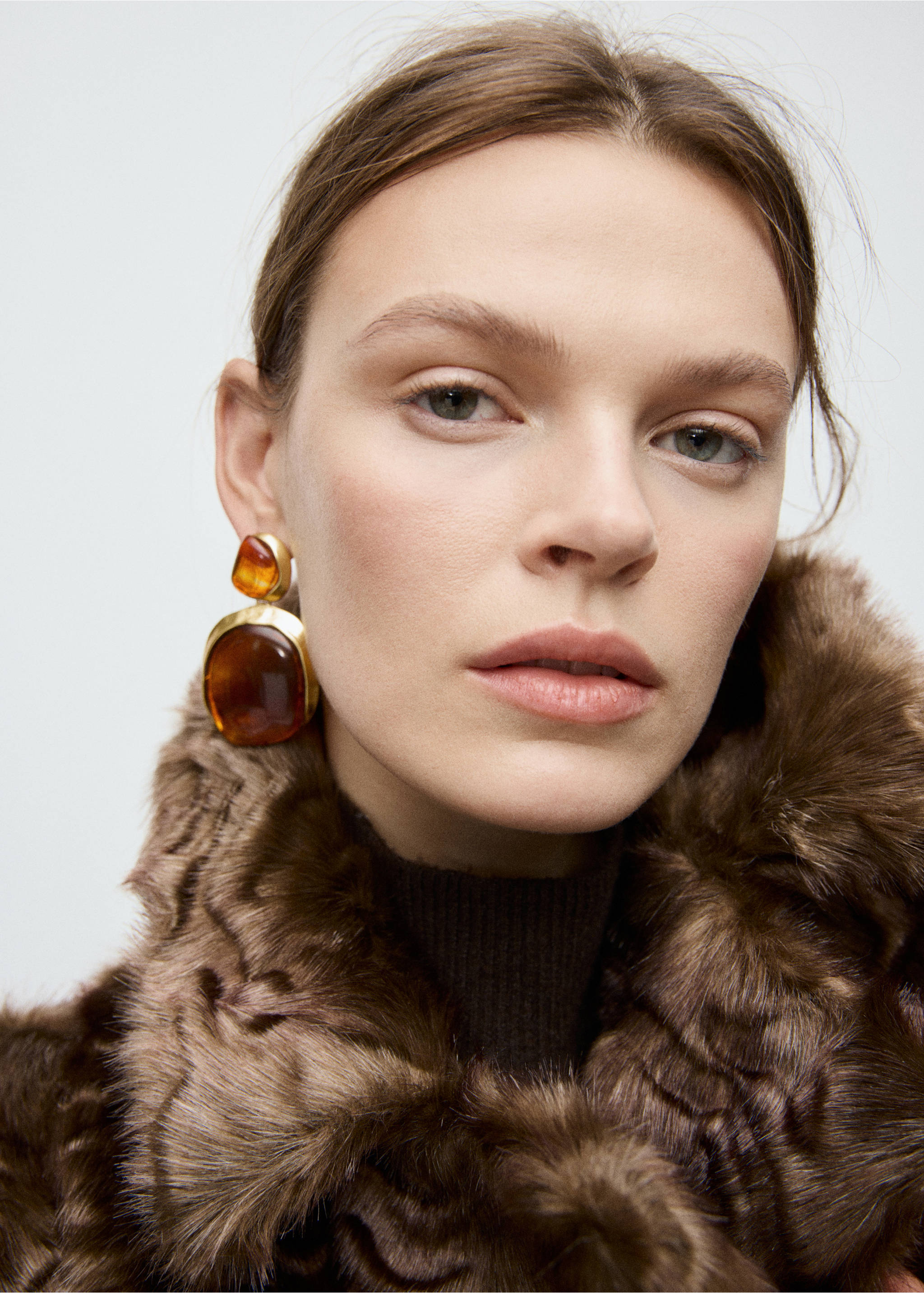 Gold-toned drop earrings with large amber-coloured resin stones worn by a model., Gold. Ref: 27051292-00.