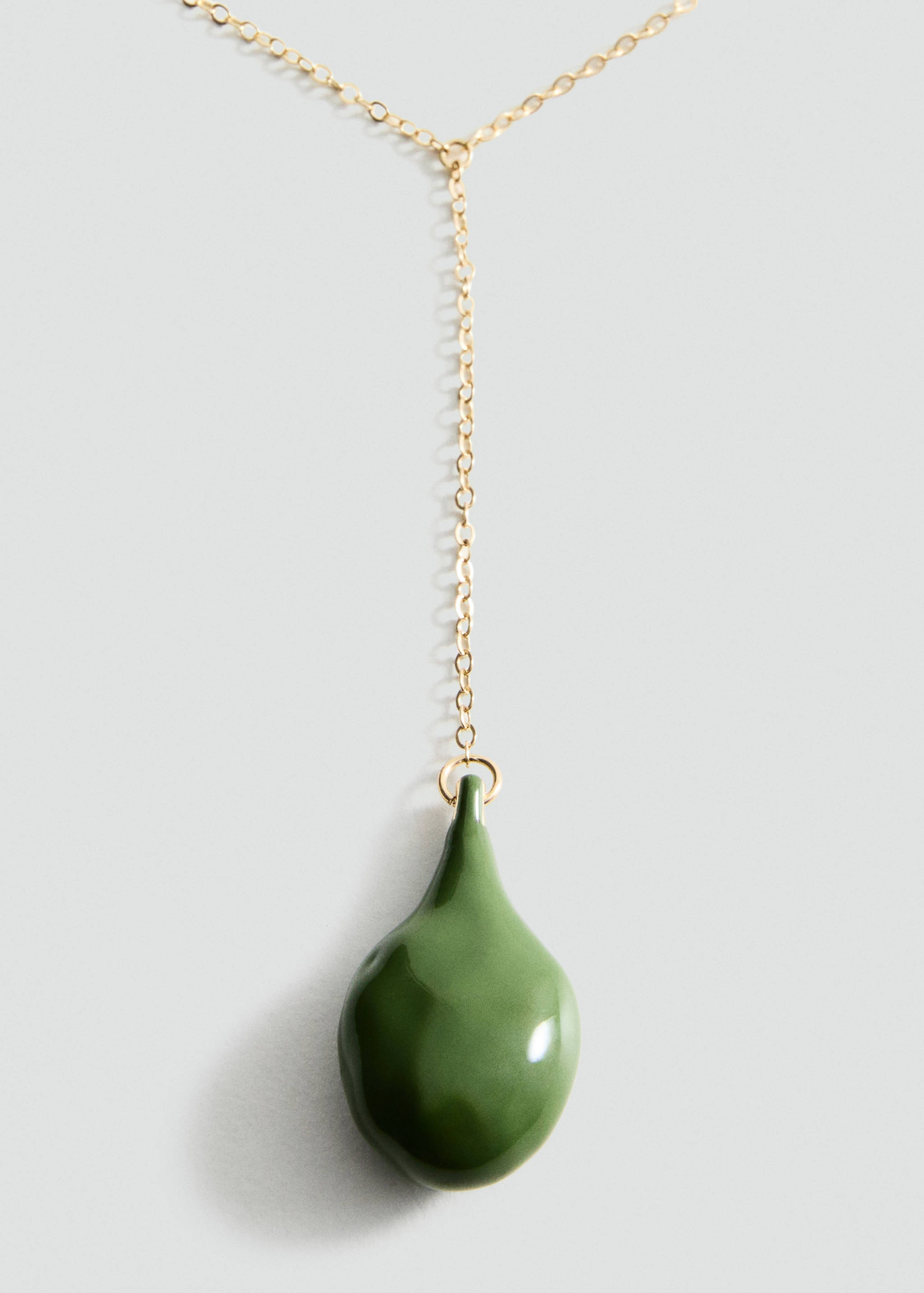 Gold chain necklace with a glossy green teardrop pendant.