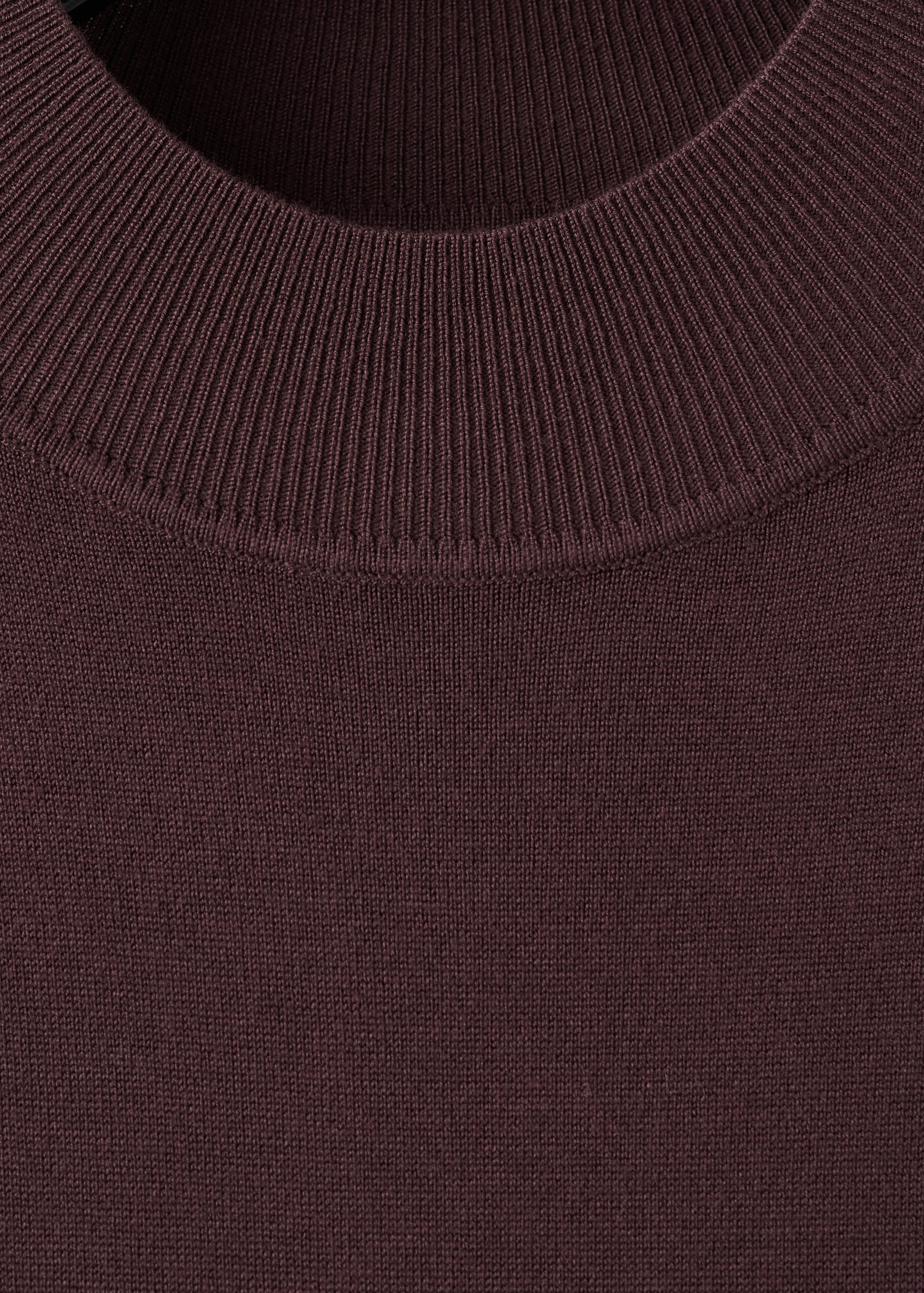 Dark burgundy knit dress detail focusing on the high ribbed neckline.