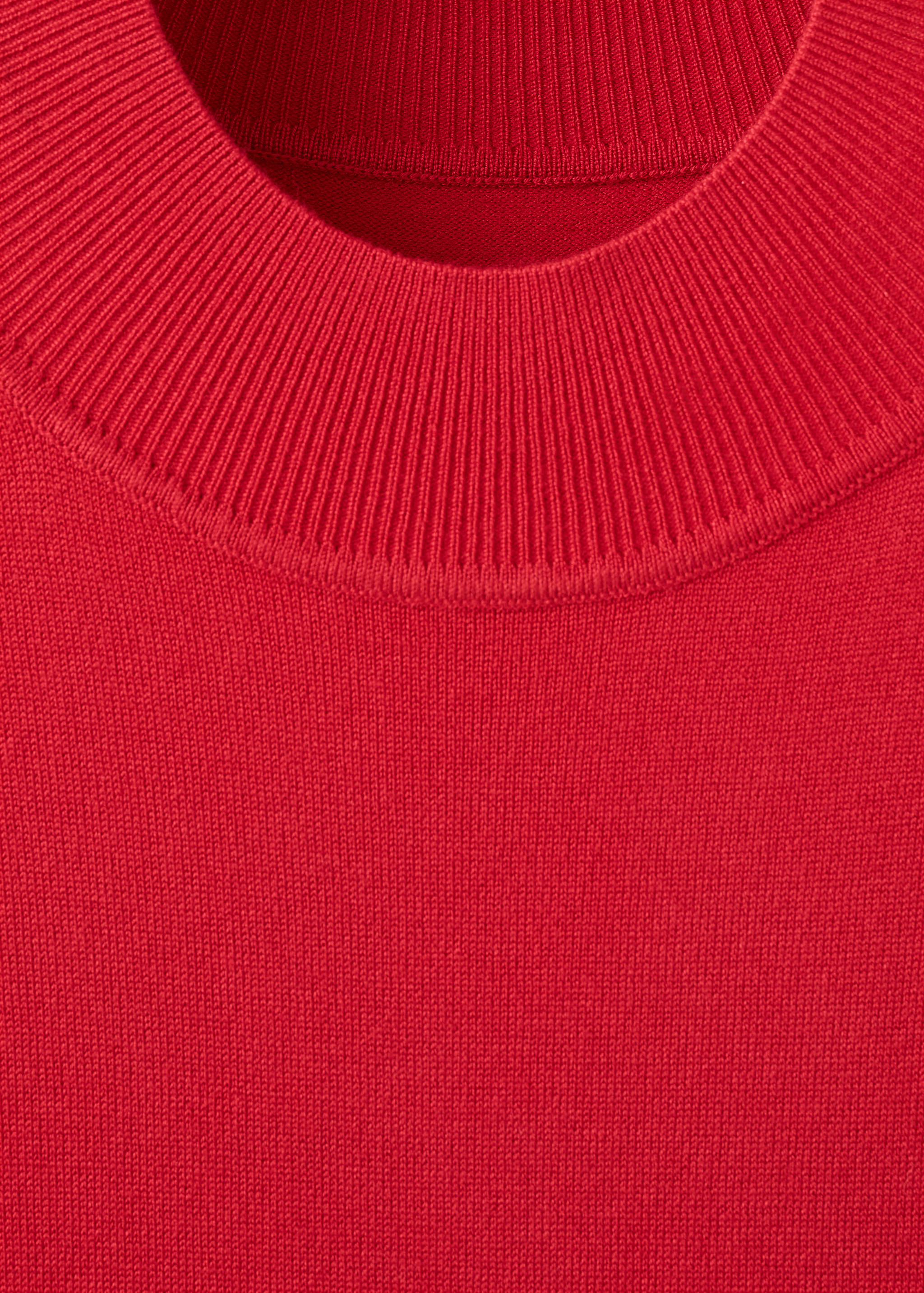 Close-up of the red knitted dress neckline.