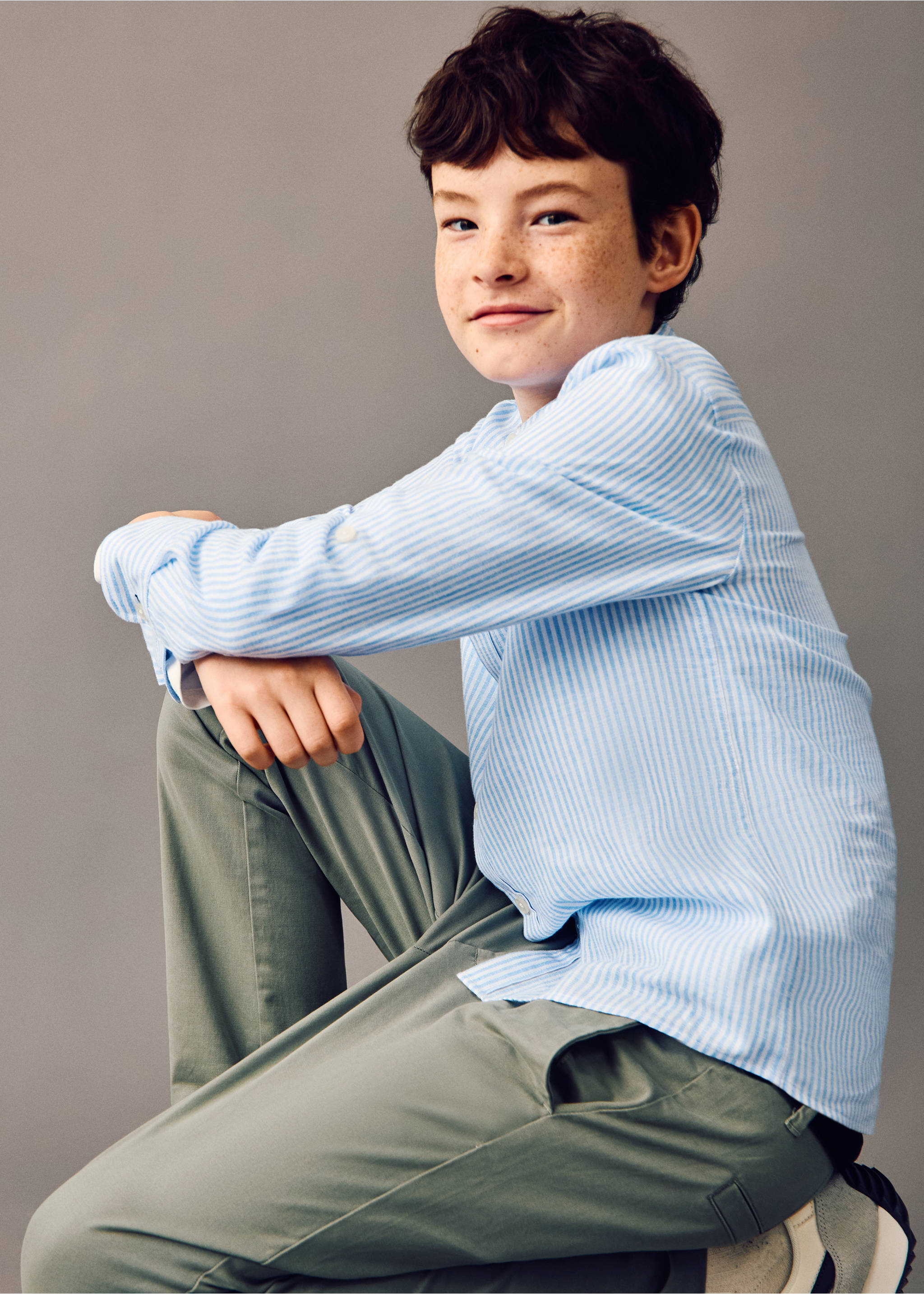 Sage green trousers worn with a blue and white striped shirt., Khaki. Ref: 27054403-00.