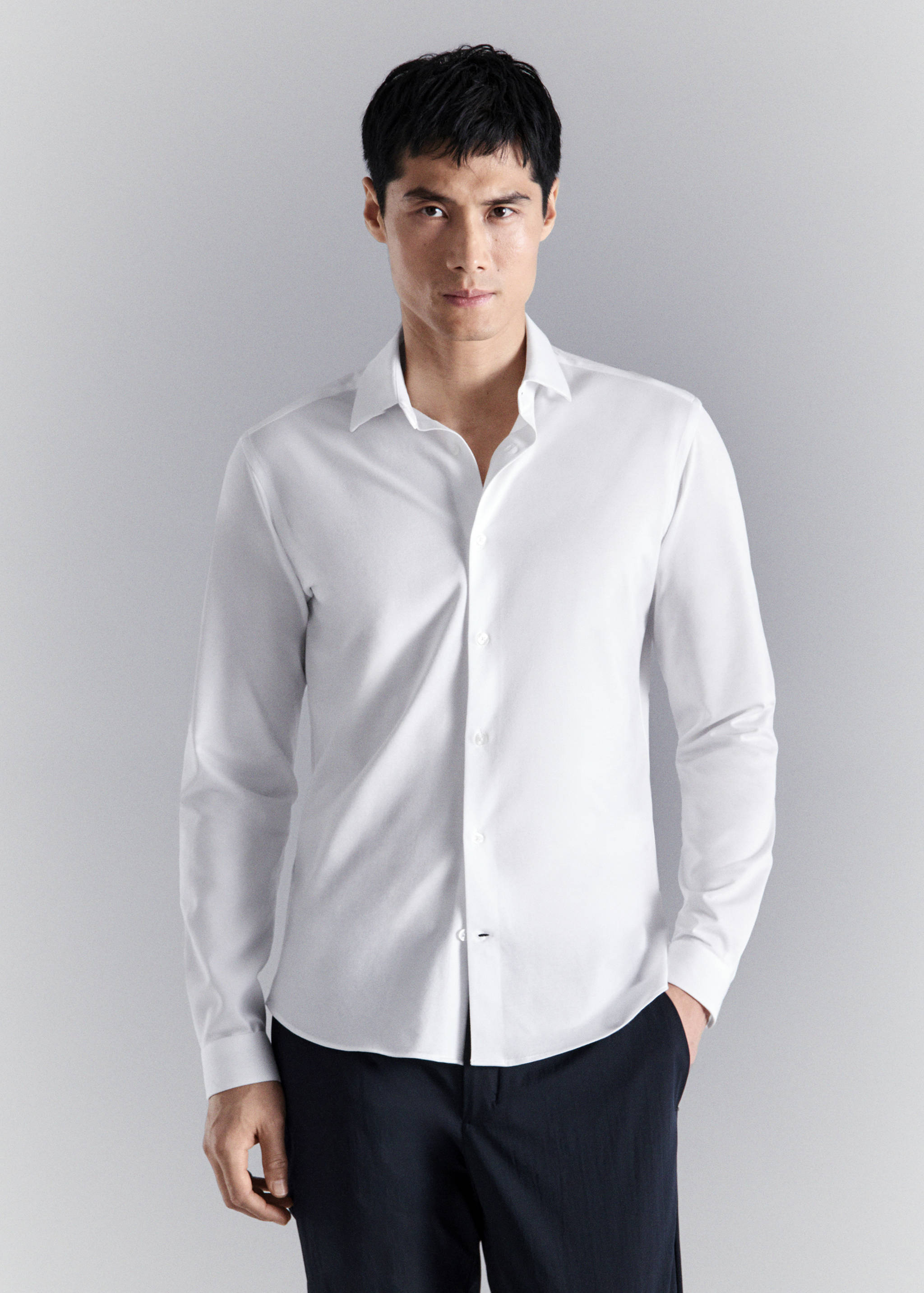 White long-sleeved shirt with a classic collar and front buttons.