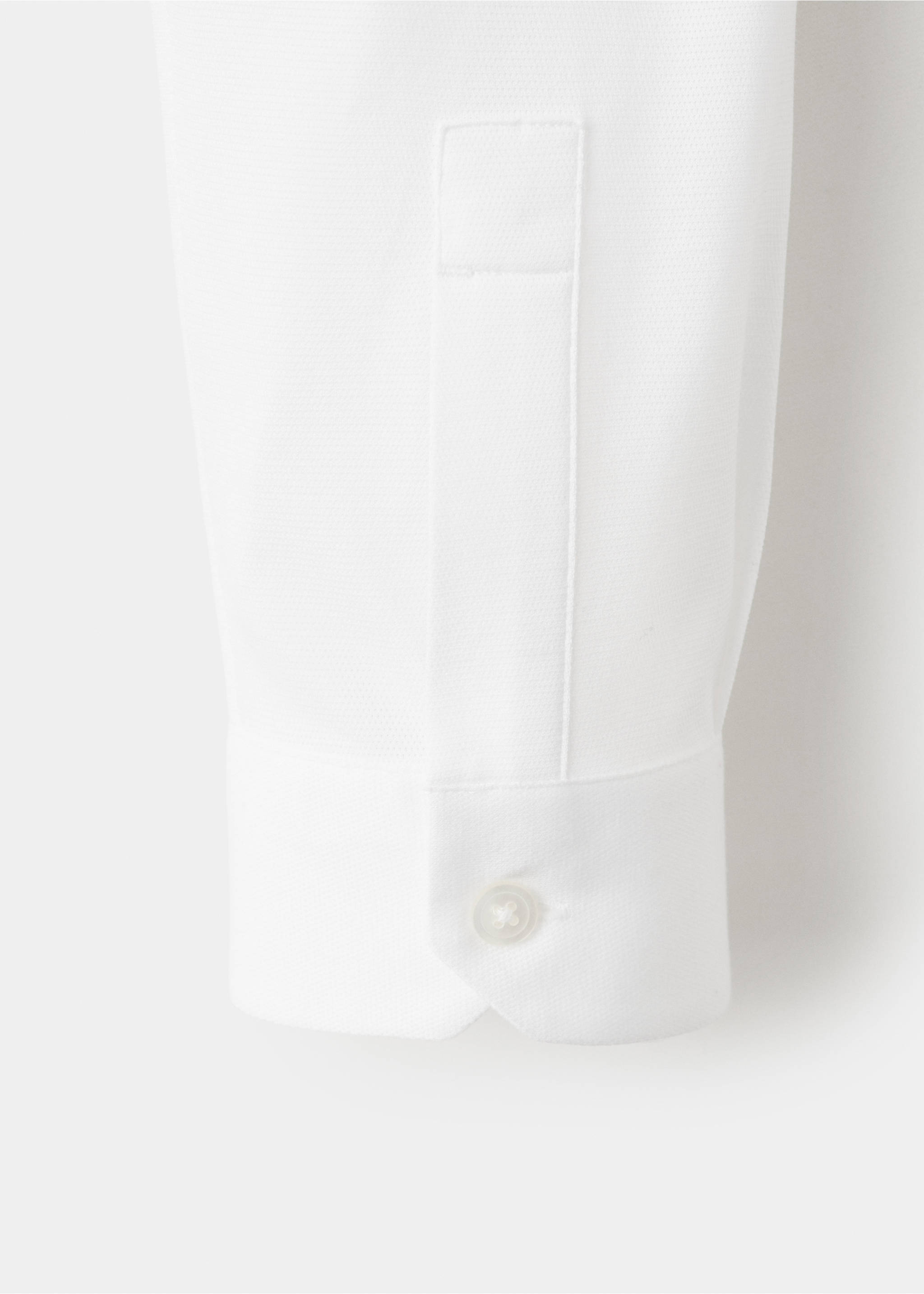 Close-up of a white shirt cuff and fabric detail., White. Ref: 27054422-00.