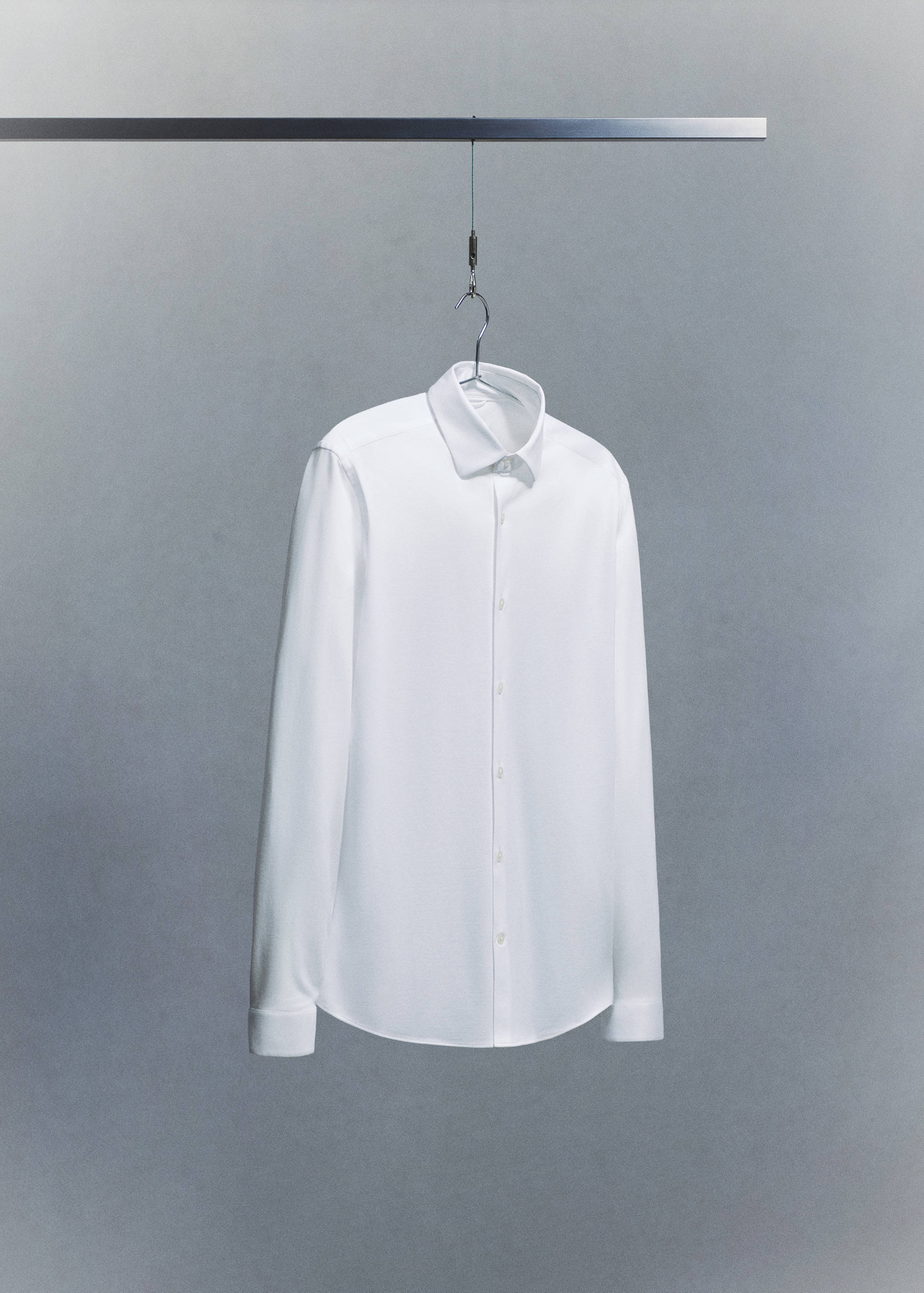 White long-sleeved shirt with a classic collar and button placket.
