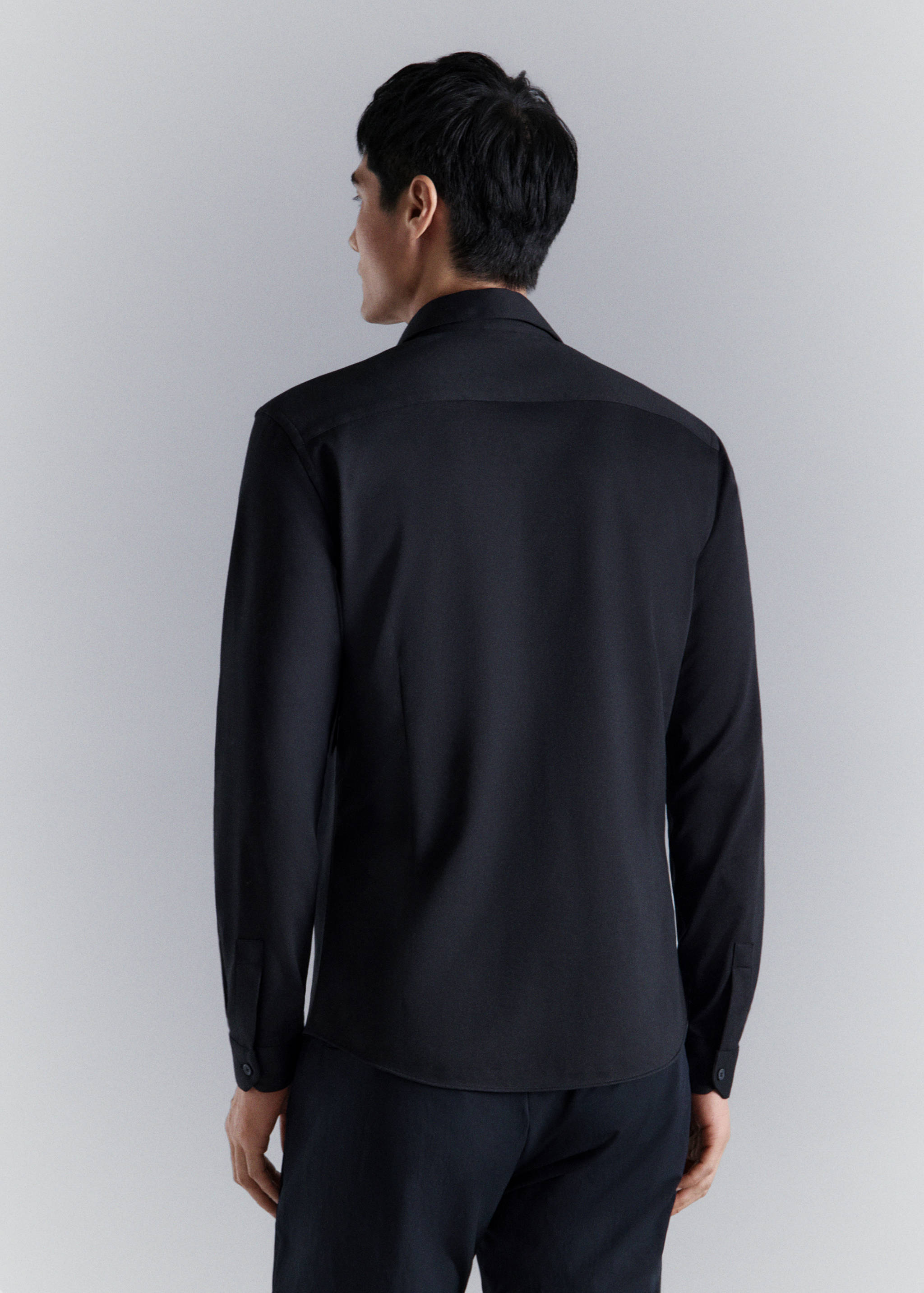 Black long-sleeved shirt, back view.