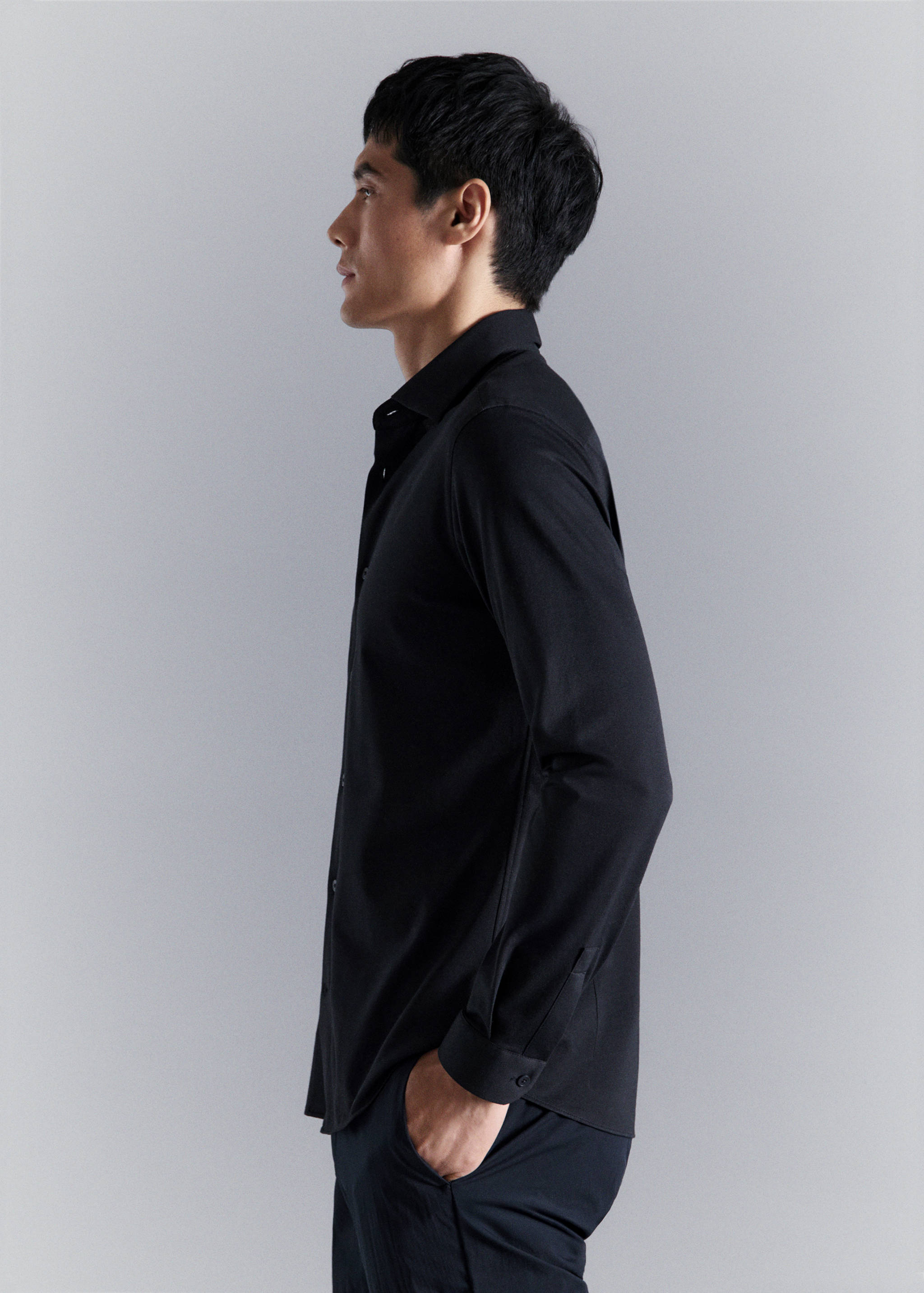 Black long-sleeved shirt with a classic collar and button-down fastening.
