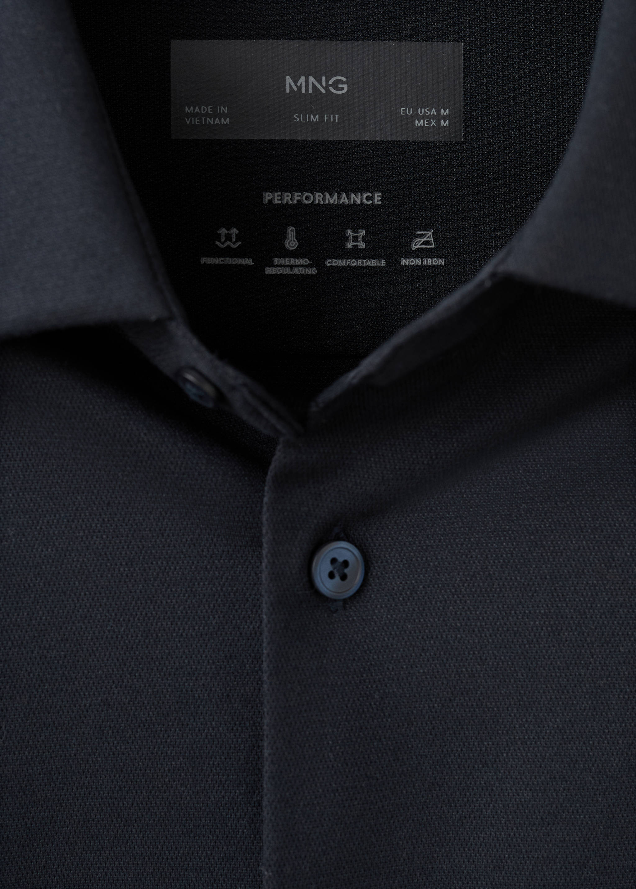Close-up of a black slim-fit shirt collar showing the inner performance label.