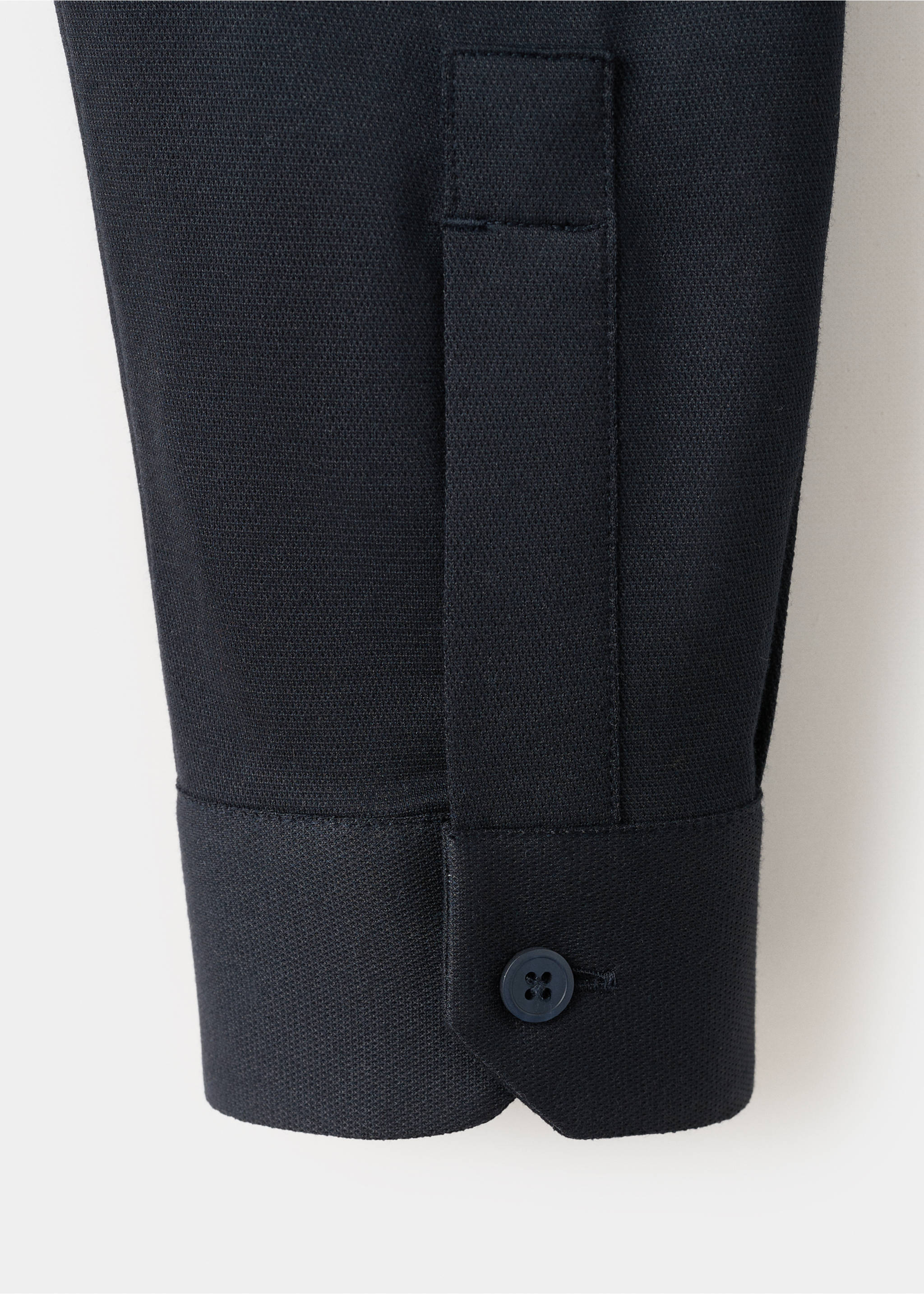 Close-up of a dark navy shirt sleeve with a buttoned cuff and textured fabric., Navy. Ref: 27054422-00.