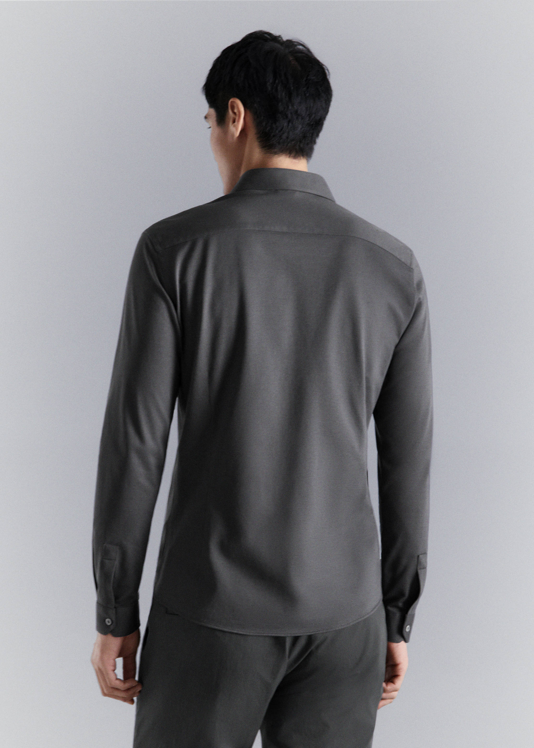 Dark grey long-sleeved shirt, back view.